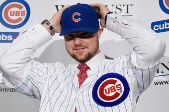 CHICAGO, IL - DECEMBER 15:  Pitcher Jon Lester puts on a Cubs hat during an introduction press conference by the Chicago Cubs on December 15, 2014  in Chicago, Illinois. (Photo by David Banks/Getty Images)