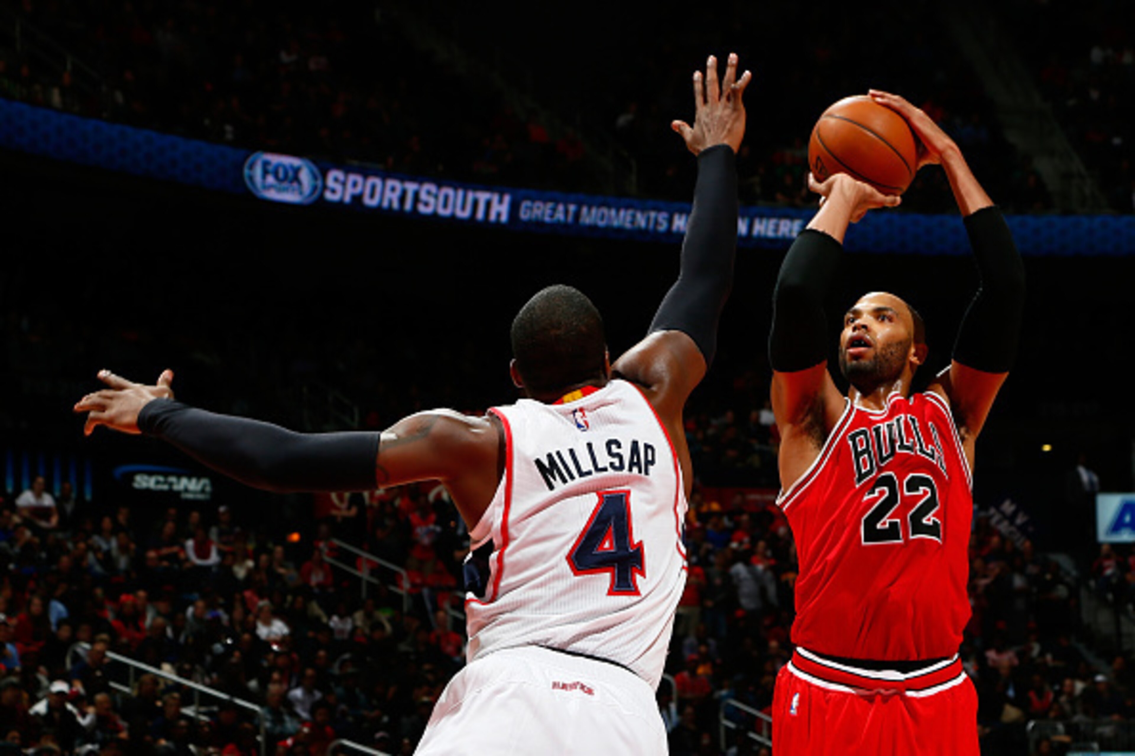 ATLANTA, GA - DECEMBER 15: Taj Gibson #22 of the Chicago Bulls shoots against Paul Millsap #4 of the Atlanta Hawks at Philips Arena on December 15, 2014 in Atlanta, Georgia. NOTE TO USER: User expressly acknowledges and agrees that, by downloading and o ATLANTA, GA - DECEMBER 15: Taj Gibson #22 of the Chicago Bulls shoots against Paul Millsap #4 of the Atlanta Hawks at Philips Arena on December 15, 2014 in Atlanta, Georgia. NOTE TO USER: User expressly acknowledges and agrees that, by downloading and o