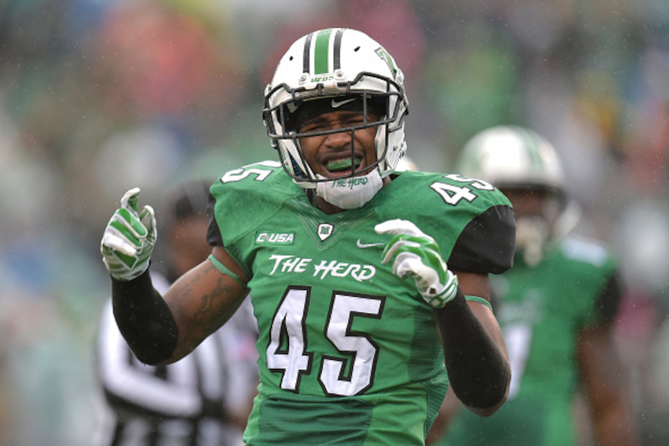 HUNTINGTON, WV - DECEMBER 06: Raheim Huskey #45 of the Marshall Thundering Herd celebrates after the Louisiana Tech Bulldogs are charged with a false start during the second quarter at Joan C. Edwards Stadium during the Conference USA championship game on