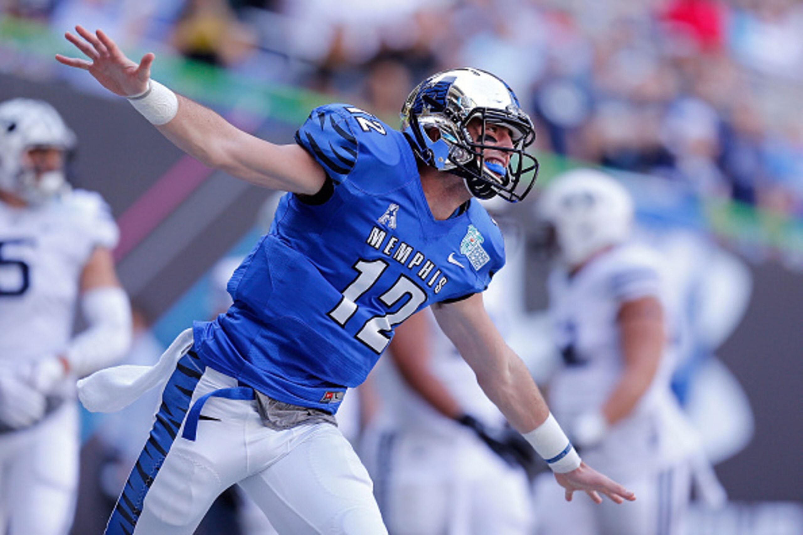 MIAMI, FL - DECEMBER 22: Paxton Lynch #12 of the Memphis Tigers reacts after throwing a touchdown pass during the first quarter of the game against the Brigham Young Cougars at Marlins Park on December 22, 2014 in Miami, Florida.  (Photo by Rob Foldy/Gett
