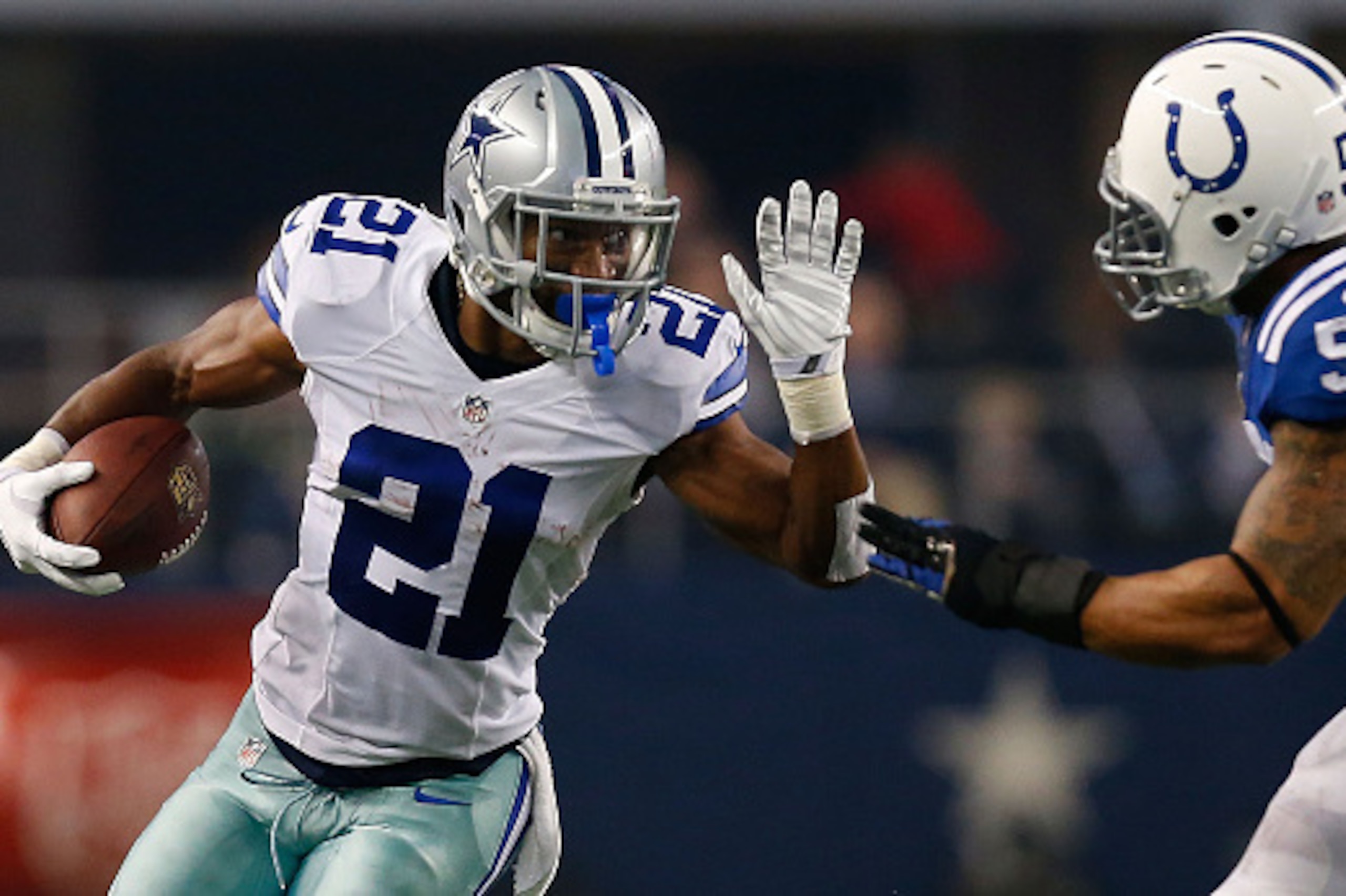 ARLINGTON, TX - DECEMBER 21:  Joseph Randle #21 of the Dallas Cowboys carries the ball as Jerrell Freeman #50 of the Indianapolis Colts tries to position for the tackle in the first half at AT&T Stadium on December 21, 2014 in Arlington, Texas.  (Photo by