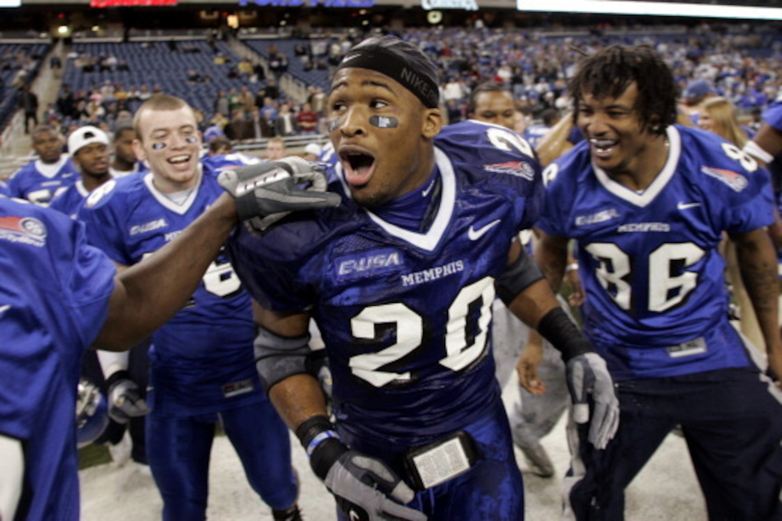Memphis Tigers DeAngelo Williams #20 is congradulated by teammates after their 38-31 victory over the Akron Zips at the Motor City Bowl at Ford Field in Detroit, Michigan on December 26, 2005. (Photo by Gregory Shamus/Getty Images)