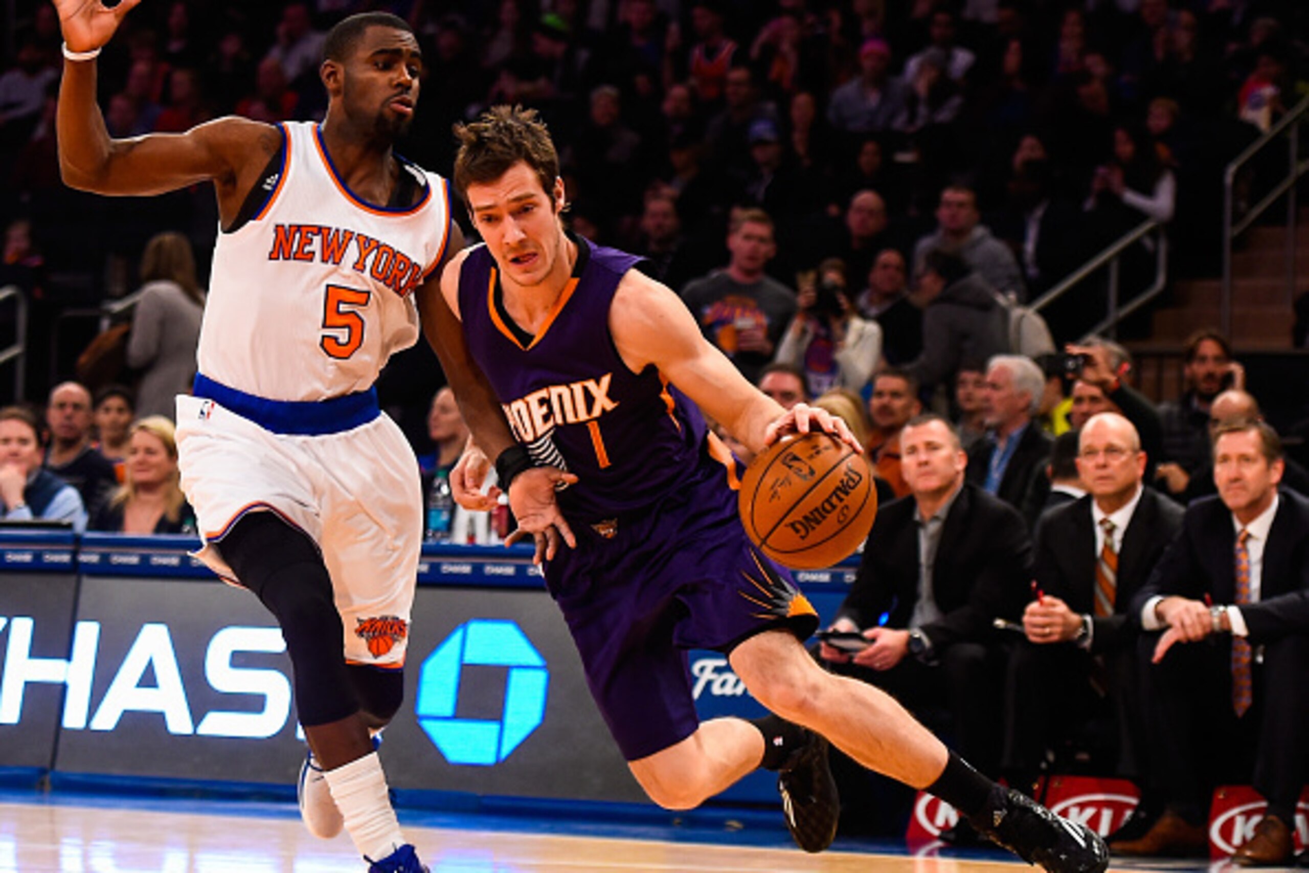 NEW YORK, NY - DECEMBER 20: Goran Dragic #1 of the Phoenix Suns drives around Tim Hardaway Jr. #5 of the New York Knicks in the first half at Madison Square Garden on December 20, 2014 in New York City. NOTE TO USER: User expressly acknowledges and agrees
