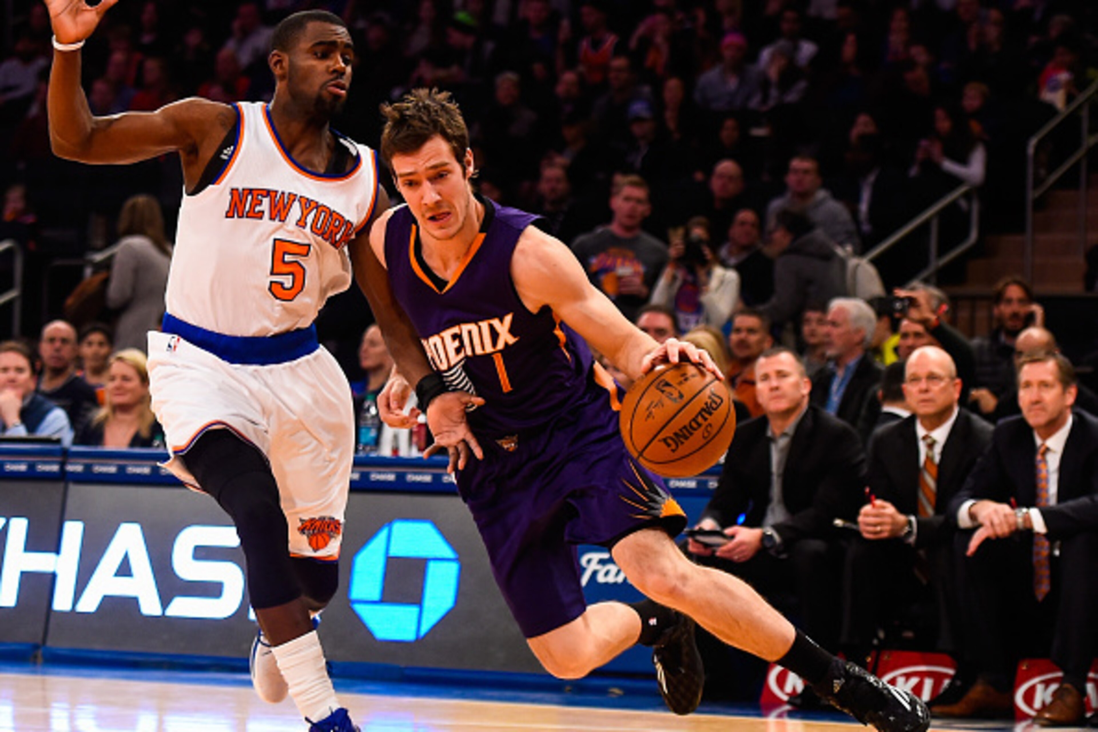 NEW YORK, NY - DECEMBER 20: Goran Dragic #1 of the Phoenix Suns drives around Tim Hardaway Jr. #5 of the New York Knicks in the first half at Madison Square Garden on December 20, 2014 in New York City. NOTE TO USER: User expressly acknowledges and agrees