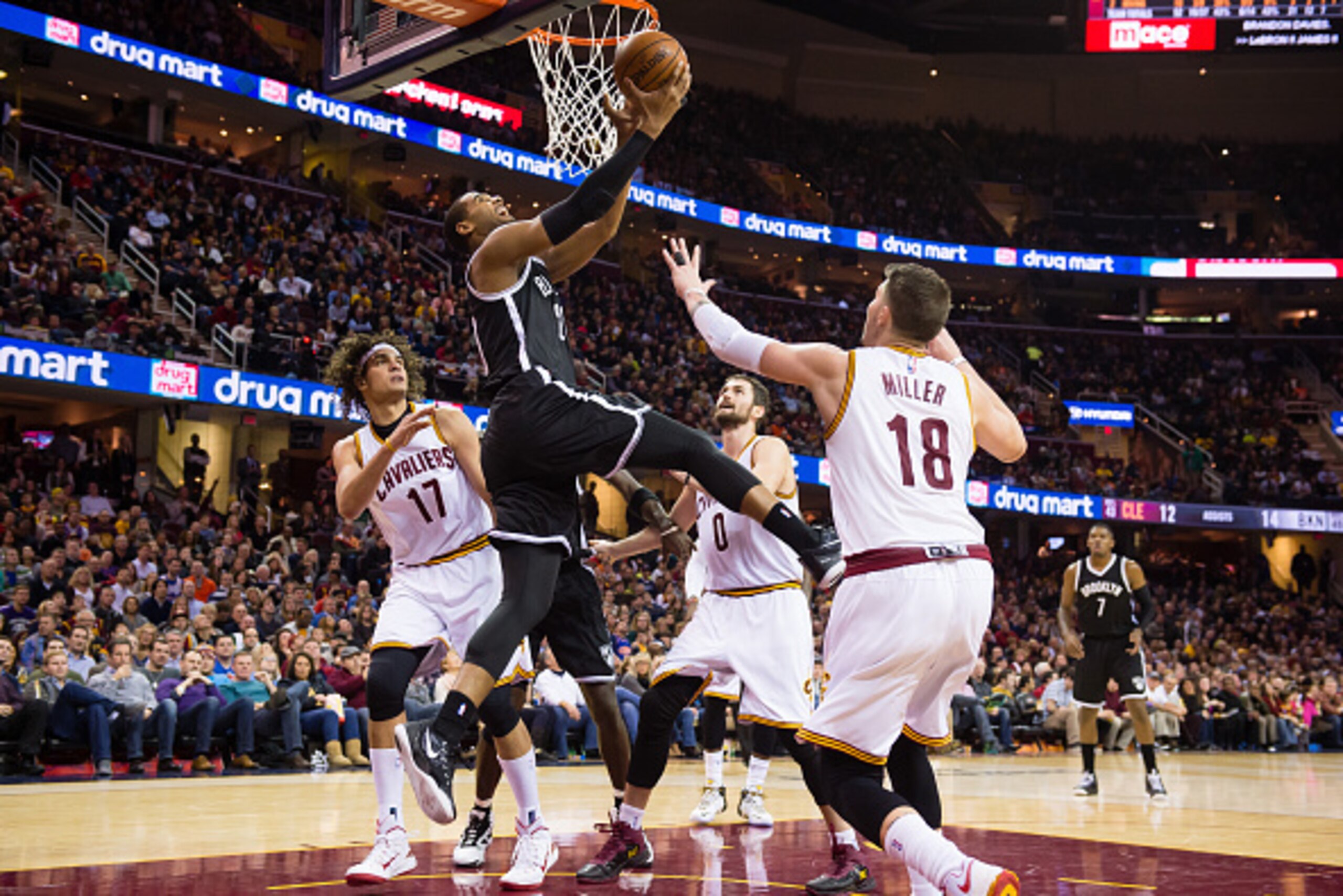 CLEVELAND, OH - DECEMBER 19: Brandon Davies #20 of the Brooklyn Nets shoots over Anderson Varejao #17 Kevin Love #0 and Mike Miller #18 of the Cleveland Cavaliers during the first half at Quicken Loans Arena on December 19, 2014 in Cleveland, Ohio.  NOTE 