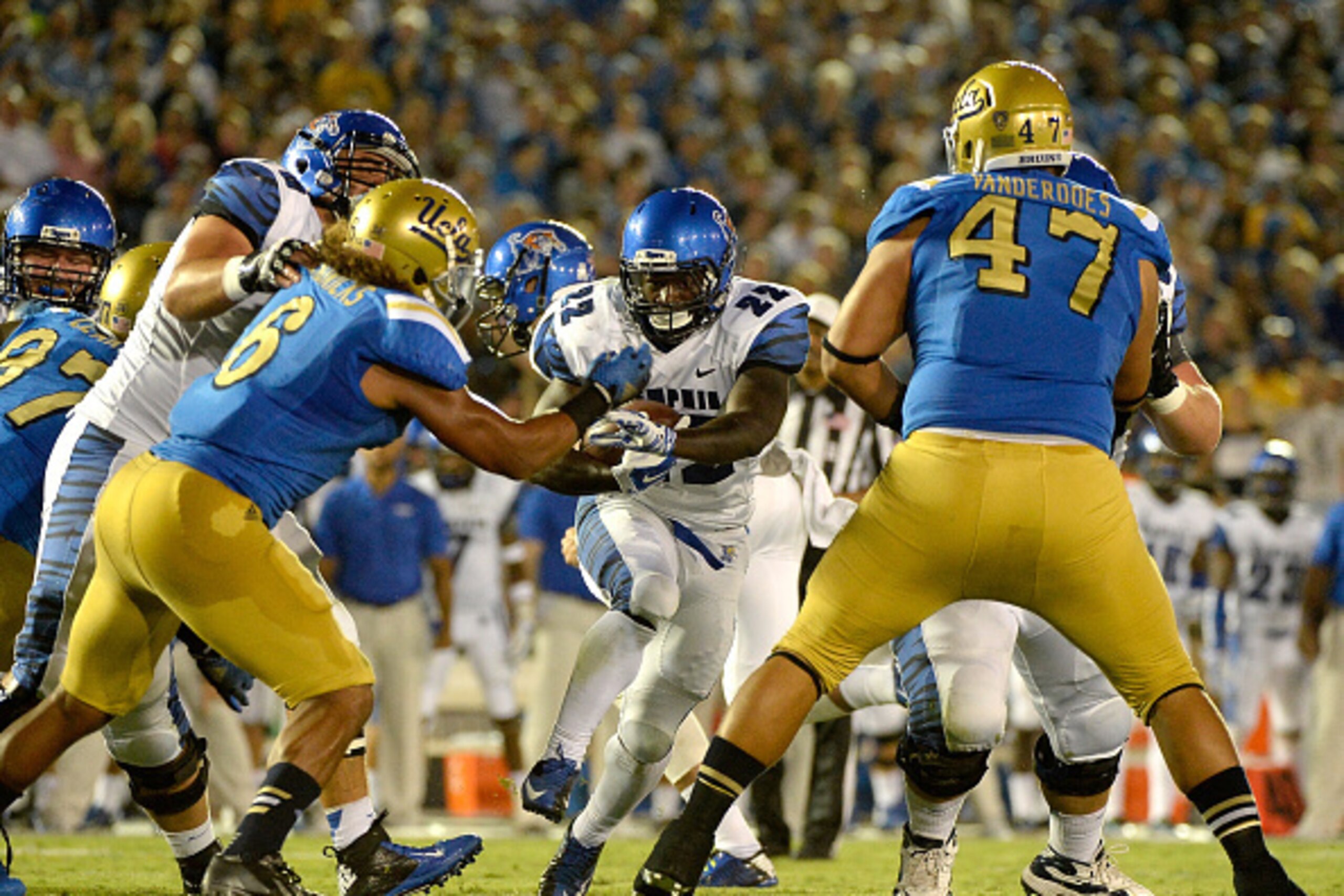 PASADENA, CA - SEPTEMBER 06:  Doroland Dorceus #22 of the Memphis Tigers runs toward a hole in the UCLA Bruins defense at Rose Bowl on September 6, 2014 in Pasadena, California.  (Photo by Harry How/Getty Images)