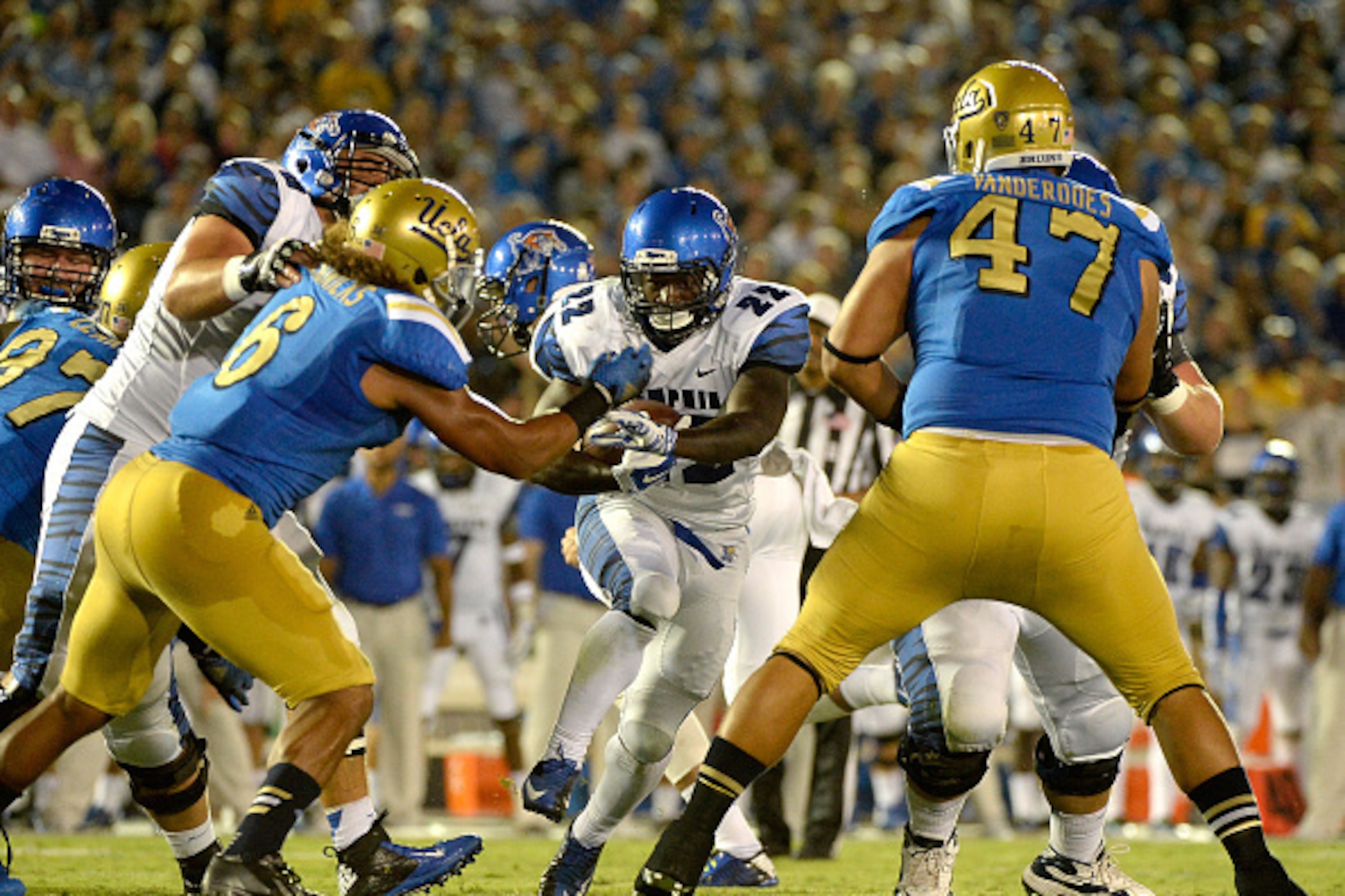 PASADENA, CA - SEPTEMBER 06: Doroland Dorceus #22 of the Memphis Tigers runs toward a hole in the UCLA Bruins defense at Rose Bowl on September 6, 2014 in Pasadena, California. (Photo by Harry How/Getty Images) PASADENA, CA - SEPTEMBER 06: Doroland Dorceus #22 of the Memphis Tigers runs toward a hole in the UCLA Bruins defense at Rose Bowl on September 6, 2014 in Pasadena, California. (Photo by Harry How/Getty Images)