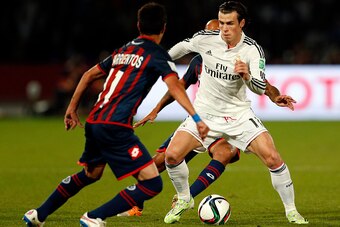 MARRAKECH, MOROCCO - DECEMBER 20: Gareth Bale of Real Madrid CF takes on the San Lorenzo defence during the FIFA Club World Cup Final match between Real Madrid CF and San Lorenzo at Le Grand Stade de Marrakech on December 20, 2014 in Marrakech, Morocco.  
