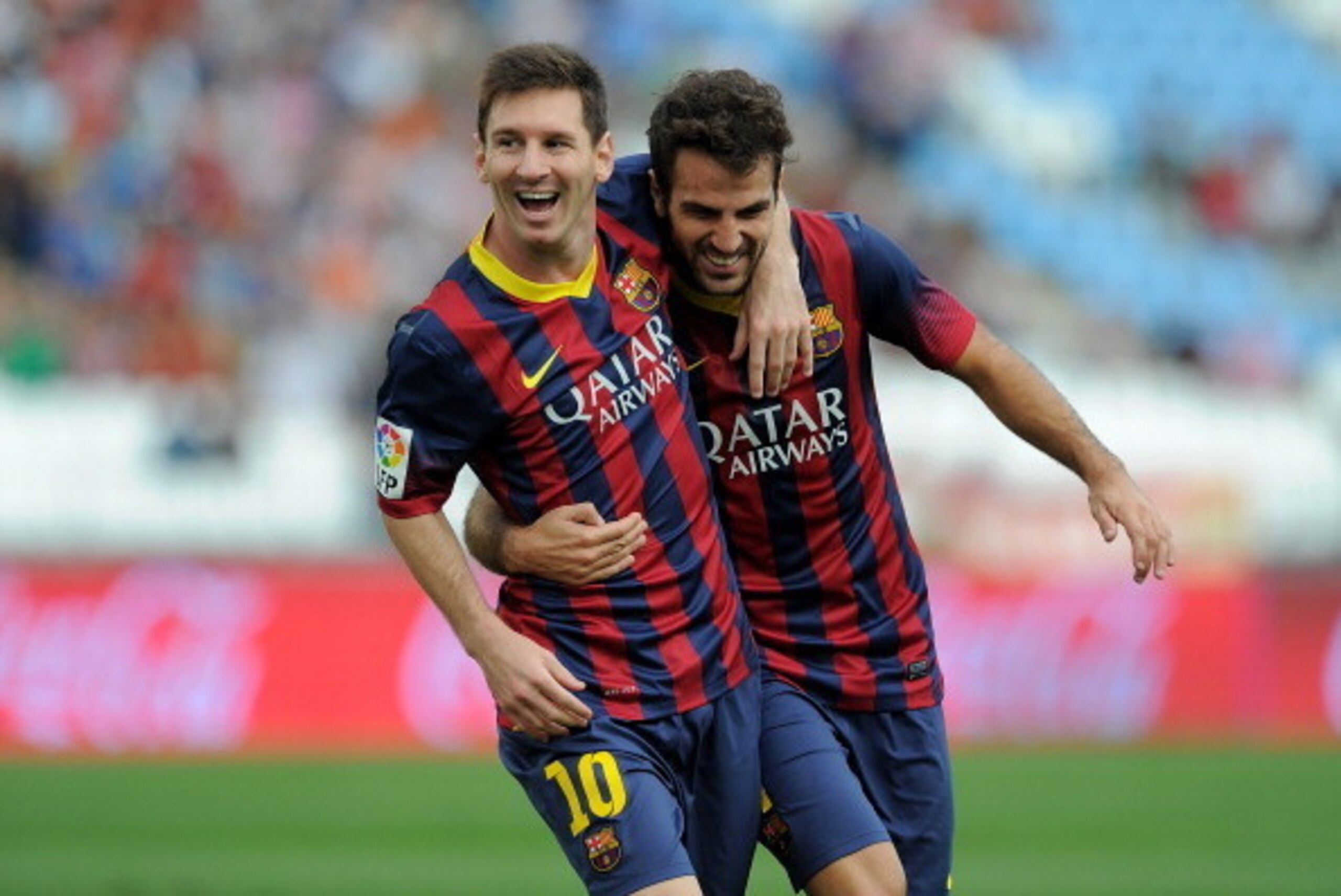 ALMERIA, SPAIN - SEPTEMBER 28:  Lionel Messi (L) of FC Barcelona celebrates with team-mate Cesc Fabregas after scoring the opening goal during the La Liga match between UD Almeria and FC Barcelona on September 28, 2013 in Almeria, Spain.  (Photo by Denis 