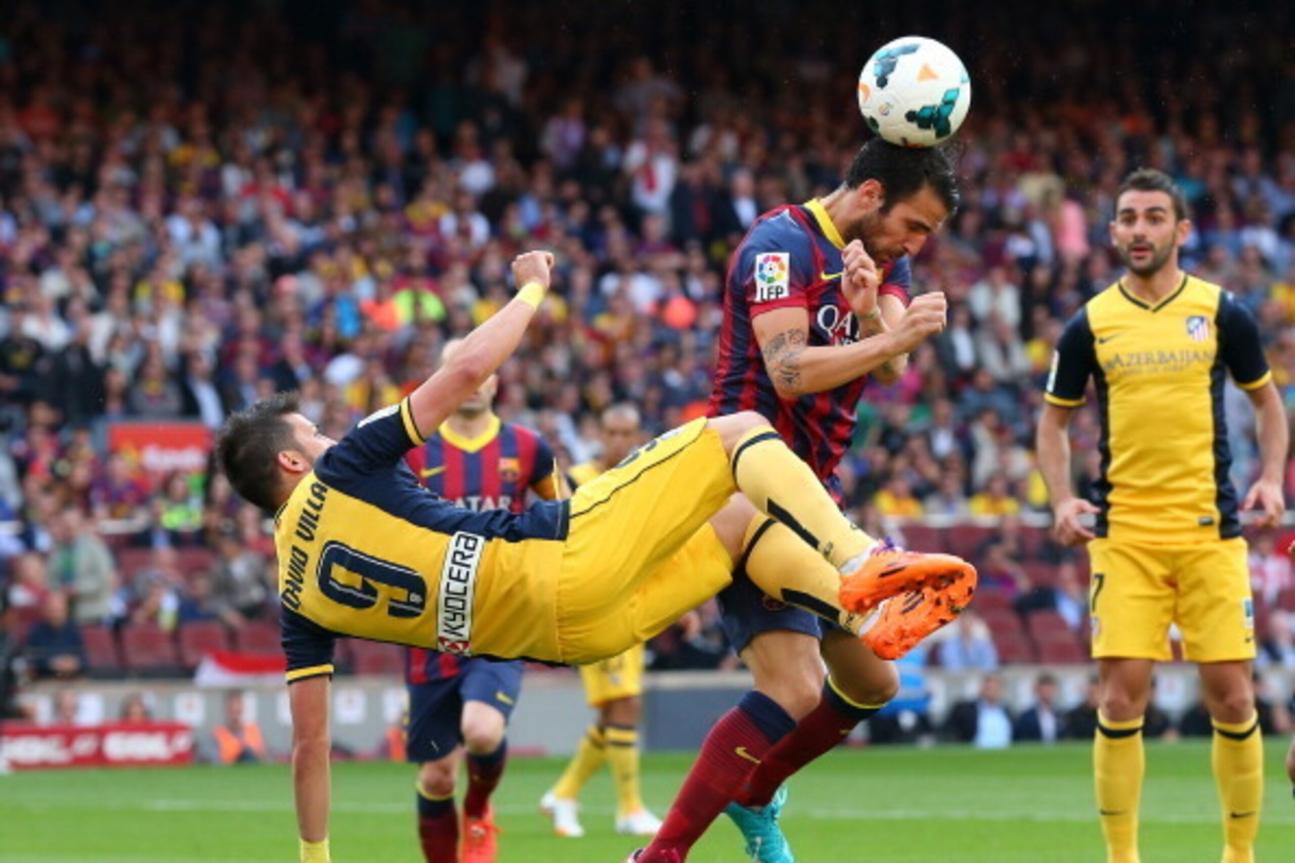 BARCELONA, SPAIN - MAY 17:  Cesc Fabregas of FC Barcelona is challeged by David Villa of Club Atletico de Madrid during the La Liga match between FC Barcelona and Club Atletico de Madrid at Camp Nou on May 17, 2014 in Barcelona, Spain.  (Photo by Alex Liv