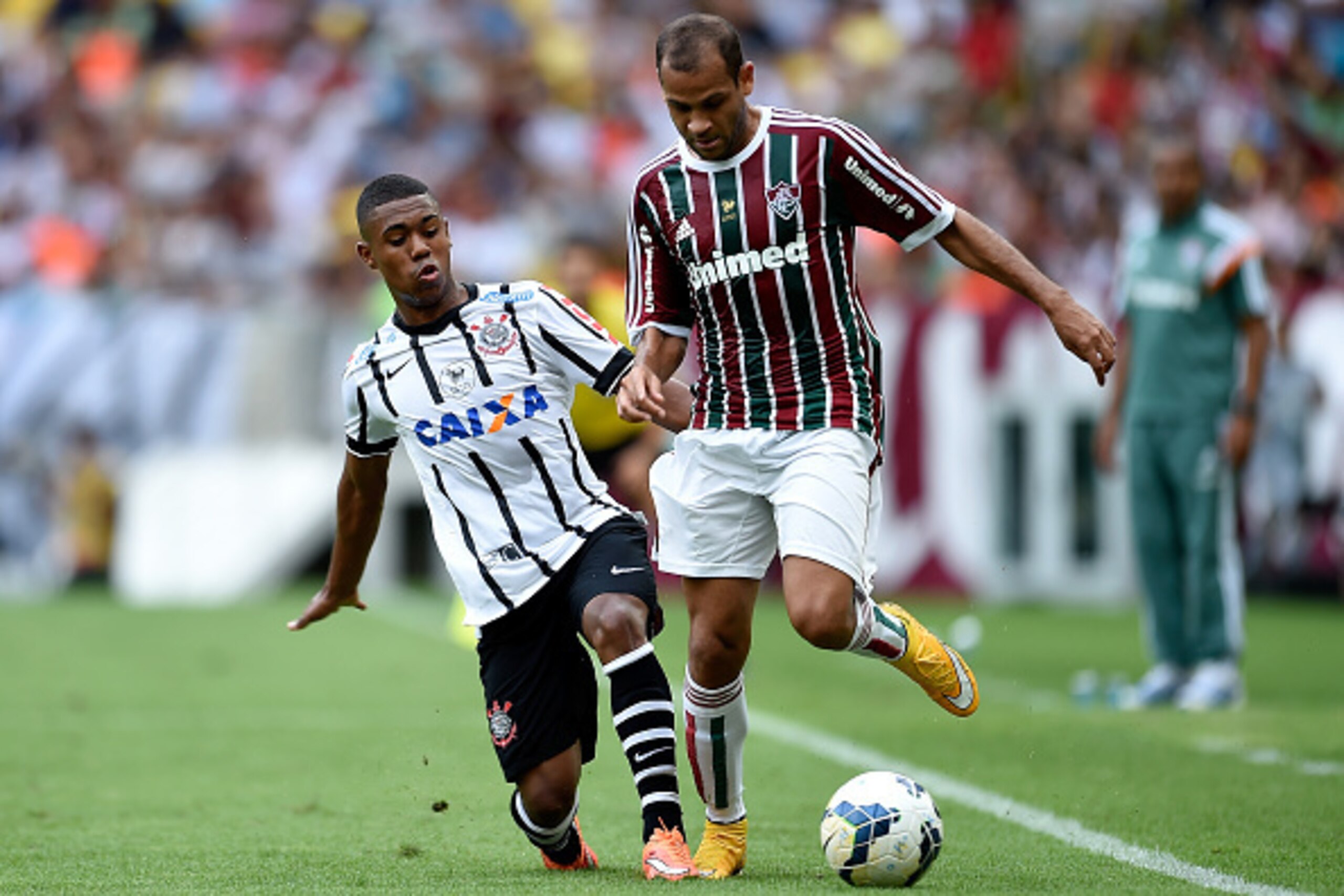 RIO DE JANEIRO, BRAZIL - NOVEMBER 30:  Carlinhos (R) of Fluminense struggles for the ball with a Malcom of Corinthians during a match between Fluminense and Corinthians as part of Brasileirao Series A 2014 at Maracana Stadium on November 30, 2014 in Rio d