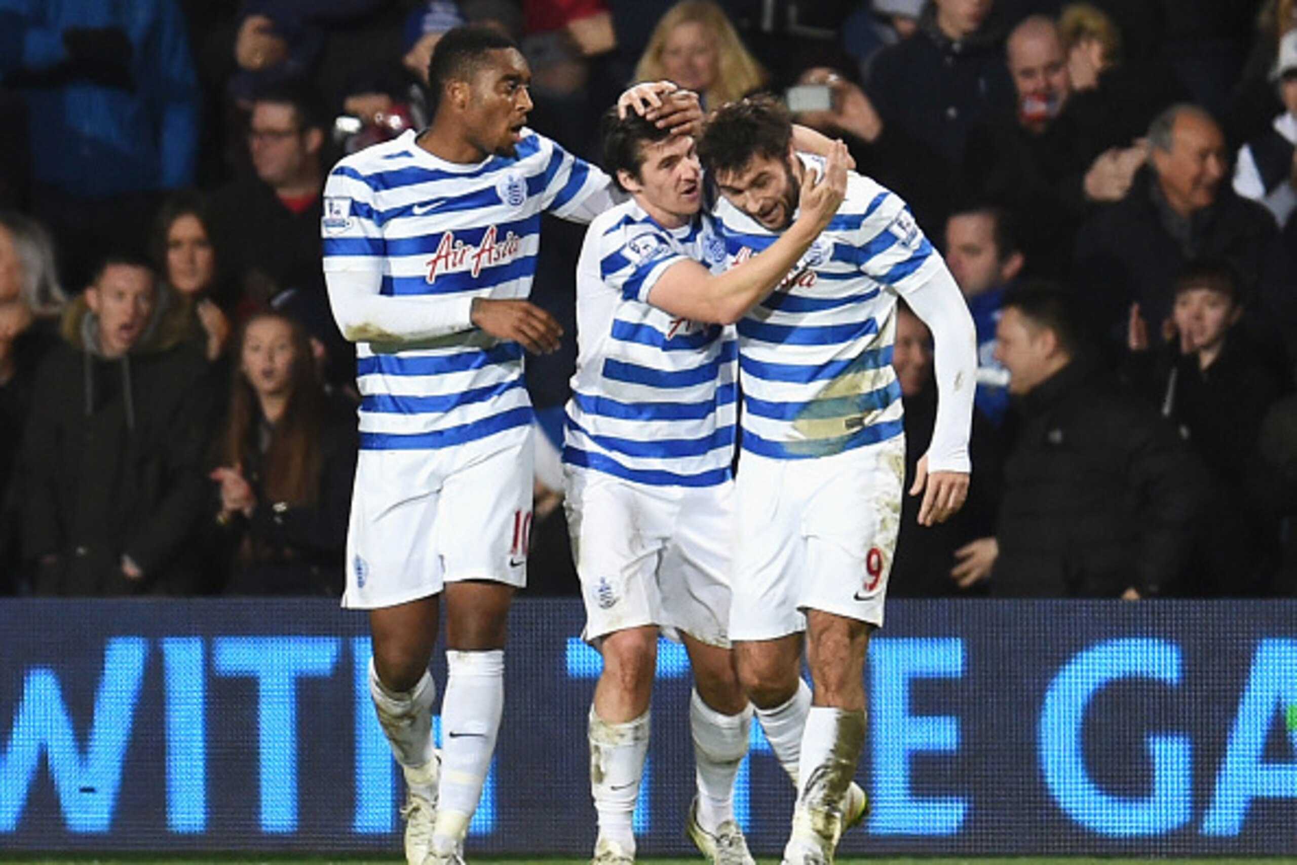 LONDON, ENGLAND - DECEMBER 20:  Charlie Austin (R) of QPR celebrates his third goal with Joey Barton (C) during the Barclays Premier League match between Queens Park Rangers and West Bromwich Albion at Loftus Road on December 20, 2014 in London, England. 