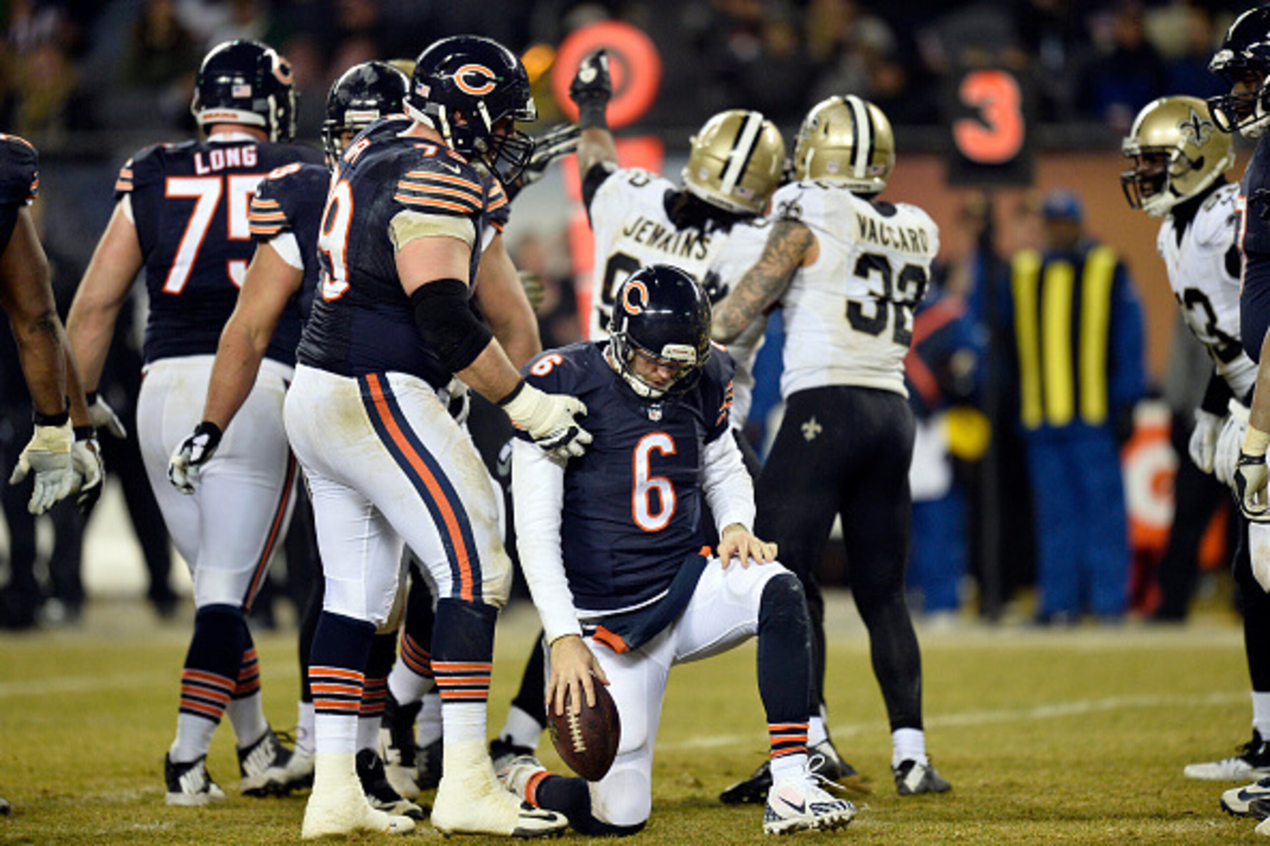 CHICAGO, IL - DECEMBER 15:  Ryan Groy #79 of the Chicago Bears helps teammate Jay Cutler #6 get up after he was sacked during the fourth quarter by John Jenkins #92 of the New Orleans Saints at Soldier Field on December 15, 2014 in Chicago, Illinois. The 