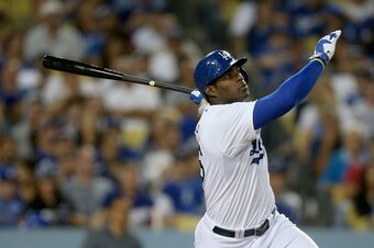 LOS ANGELES, CA - SEPTEMBER 24:  Yasiel Puig #66 of the Los Angeles Dodgers hits a solo home run against the San Francisco Giants in the sixth inning at Dodger Stadium on September 24, 2014 in Los Angeles, California.  (Photo by Jeff Gross/Getty Images)