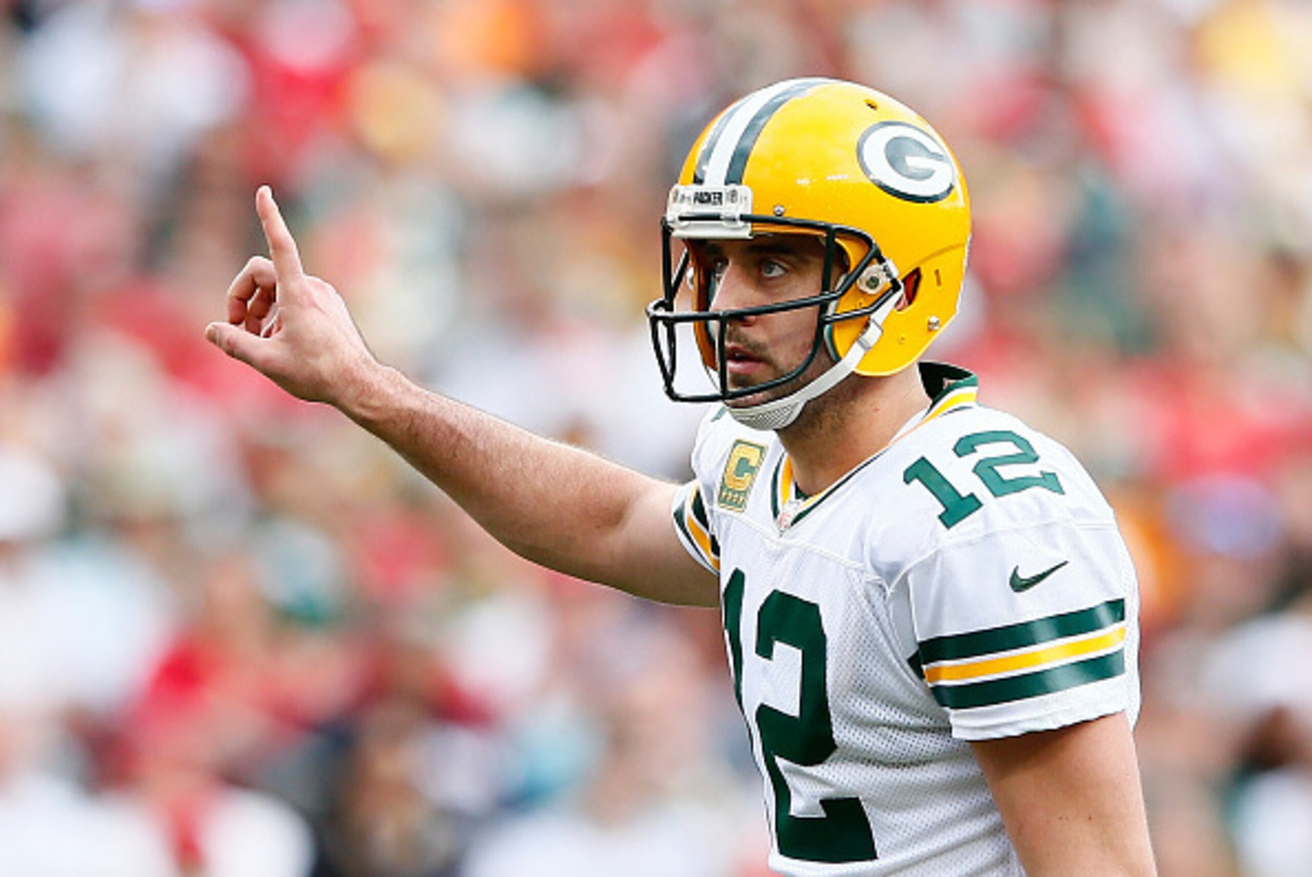 TAMPA, FL - DECEMBER 21:  Aaron Rodgers #12 of the Green Bay Packers signals to his offense during the game against the Tampa Bay Buccaneers at Raymond James Stadium on December 21, 2014 in Tampa, Florida.  (Photo by Kevin C. Cox/Getty Images)