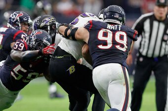 HOUSTON, TX - DECEMBER 21:  Joe Flacco #5 of the Baltimore Ravens is sacked by J.J. Watt #99 of the Houston Texans and Whitney Mercilus #59 at NRG Stadium on December 21, 2014 in Houston, Texas.  (Photo by Bob Levey/Getty Images)