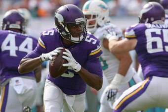 MIAMI GARDENS, FL - DECEMBER 21:  Quarterback Teddy Bridgewater #5 of the Minnesota Vikings looks for a receiver in the first quarter during a game against the Miami Dolphins at Sun Life Stadium on December 21, 2014 in Miami Gardens, Florida.  (Photo by M