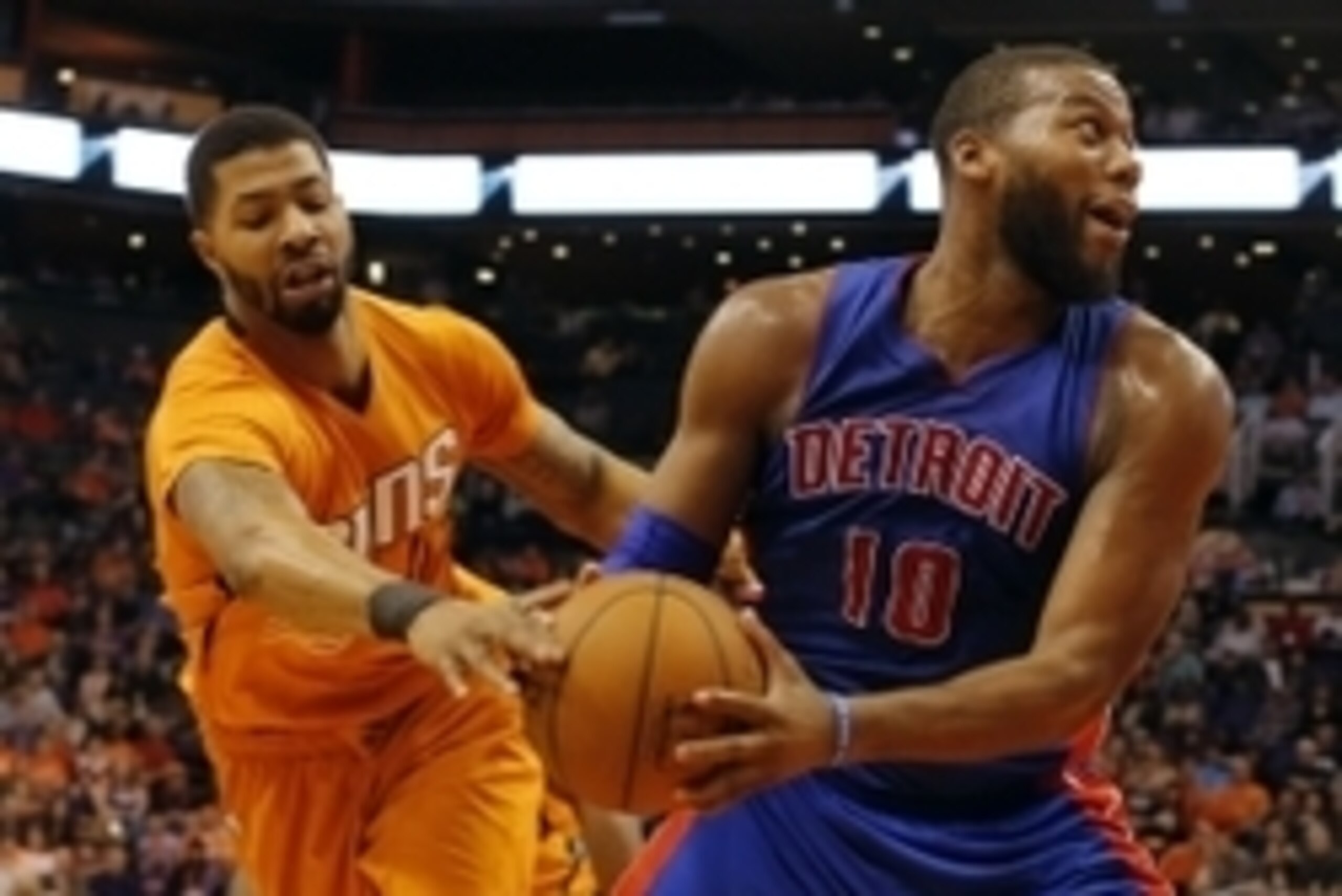 Dec 12, 2014; Phoenix, AZ, USA; Phoenix Suns forward Markieff Morris (11) tries to steal the ball on Detroit Pistons forward Greg Monroe (10) during the first quarter at US Airways Center. Mandatory Credit: Rick Scuteri-USA TODAY Sports