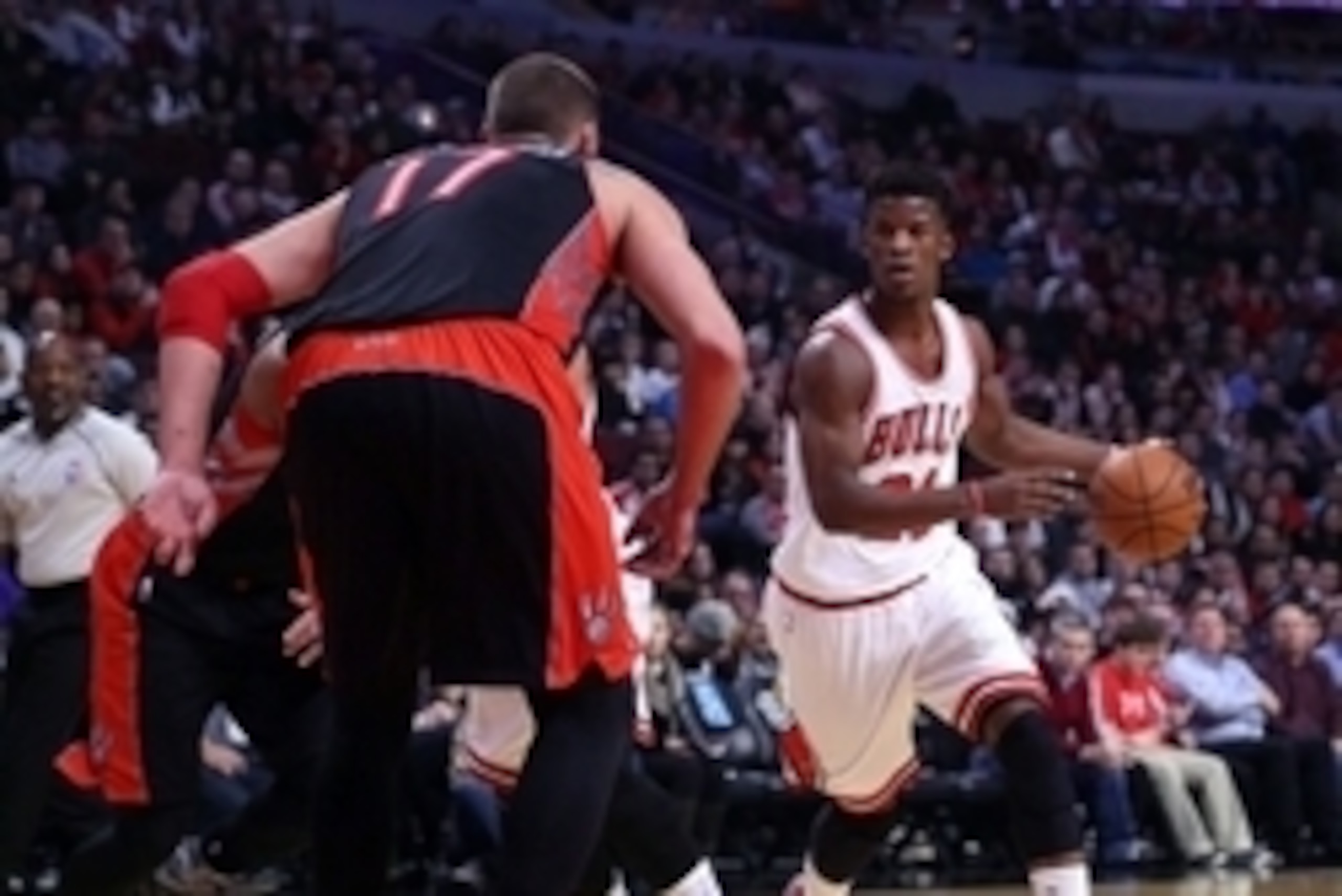 Dec 22, 2014; Chicago, IL, USA; Chicago Bulls guard Jimmy Butler (21) drives against Toronto Raptors center Jonas Valanciunas (17) during the first quarter of a game at the United Center. Mandatory Credit: Dennis Wierzbicki-USA TODAY Sports