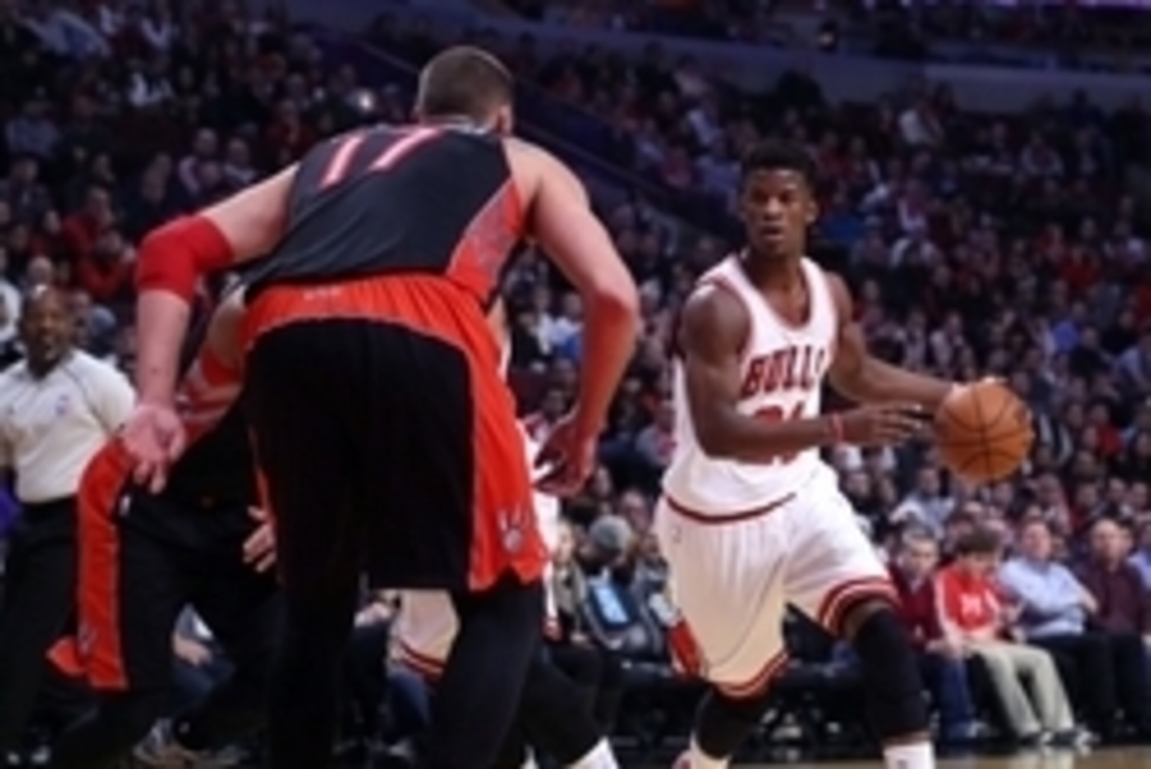 Dec 22, 2014; Chicago, IL, USA; Chicago Bulls guard Jimmy Butler (21) drives against Toronto Raptors center Jonas Valanciunas (17) during the first quarter of a game at the United Center. Mandatory Credit: Dennis Wierzbicki-USA TODAY Sports