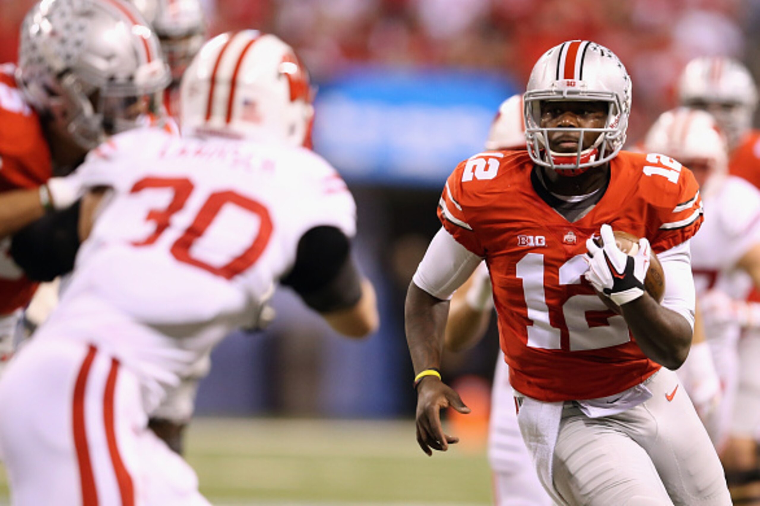 INDIANAPOLIS, IN - DECEMBER 06:  Quarterback Cardale Jones #12 of the Ohio State Buckeyes carries the ball during the second quarter against the Wisconsin Badgers in the Big Ten Championship at Lucas Oil Stadium on December 6, 2014 in Indianapolis, Indian