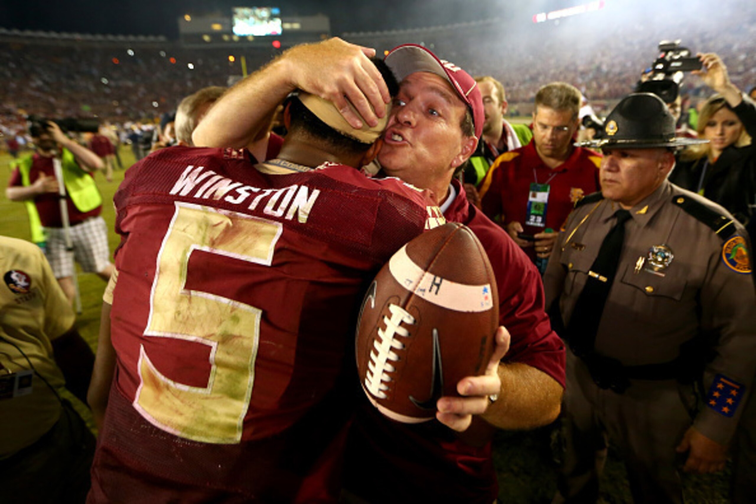 TALLAHASSEE, FL - OCTOBER 18:  Head coach Jimbo Fisher of the Florida State Seminoles hugs Jameis Winston #5 after defeating the Notre Dame Fighting Irish 31-27 in their game at Doak Campbell Stadium on October 18, 2014 in Tallahassee, Florida.  (Photo by