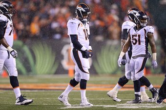 CINCINNATI, OH - DECEMBER 22:  Peyton Manning #18 of the Denver Broncos walks off of the field after throwing an interception to Dre Kirkpatrick #27 of the Cincinnati Bengals during the fourth quarter at Paul Brown Stadium on December 22, 2014 in Cincinna