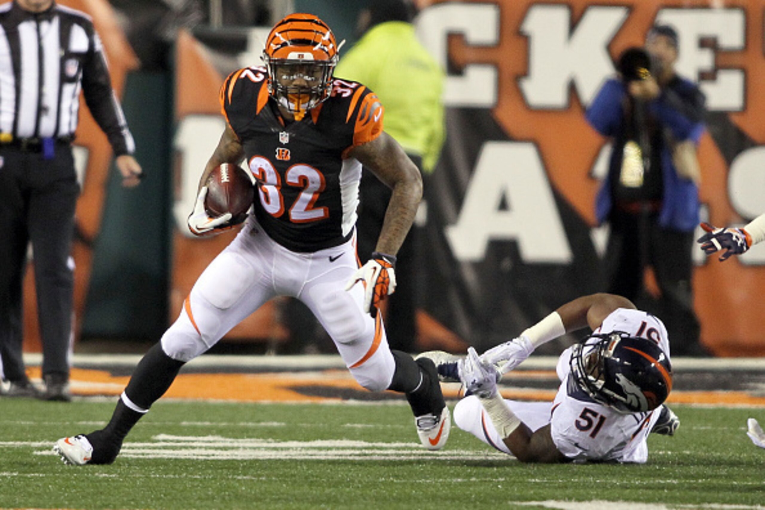 CINCINNATI, OH - DECEMBER 22:  Jeremy Hill #32 of the Cincinnati Bengals breaks a tackle by Todd Davis #51 of the Denver Broncos and runs the ball 85 yards for a touchdown during the first quarter at Paul Brown Stadium on December 22, 2014 in Cincinnati, 