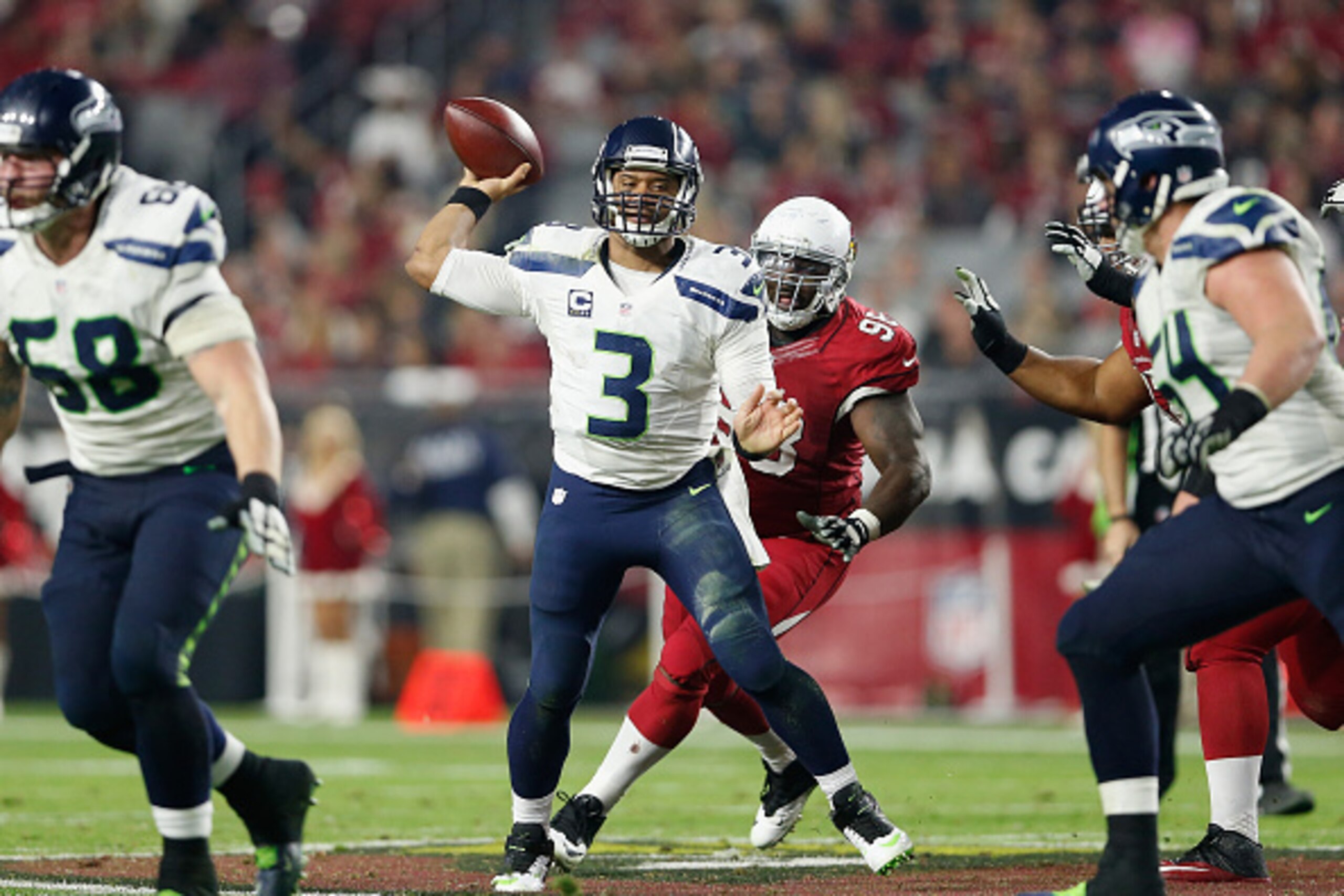 GLENDALE, AZ - DECEMBER 21:  Quarterback Russell Wilson #3 of the Seattle Seahawks throws a pass during the fourth quarter of the NFL game against the Arizona Cardinals at the University of Phoenix Stadium on December 21, 2014 in Glendale, Arizona.   The 
