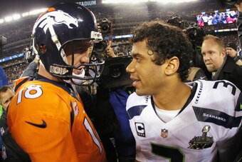 EAST RUTHERFORD, NJ - FEBRUARY 02:  (L-R) Quarterback Peyton Manning #18 of the Denver Broncos congratulates quarterback Russell Wilson #3 of the Seattle Seahawks on their 43-8 win during Super Bowl XLVIII at MetLife Stadium on February 2, 2014 in East Ru