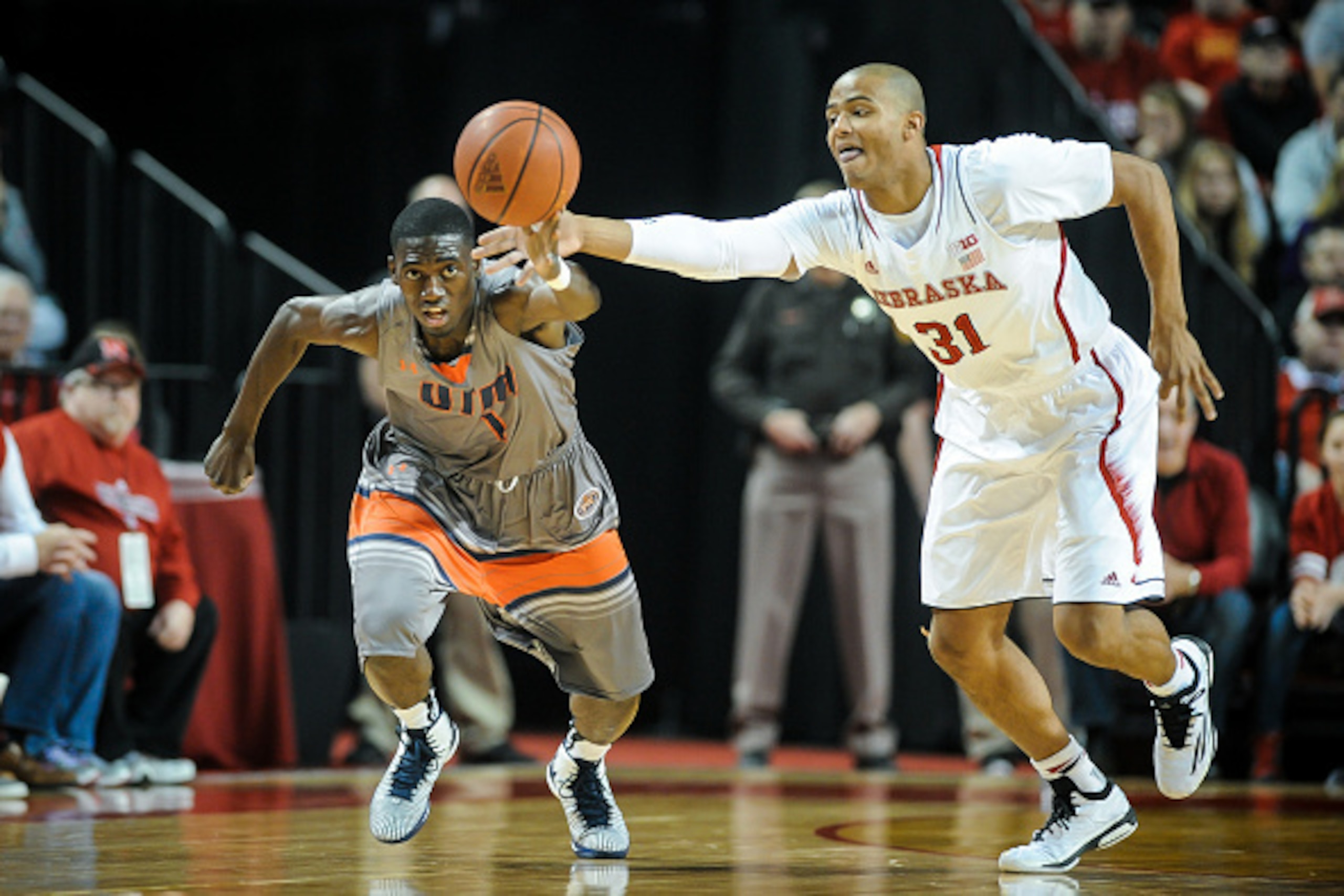 LINCOLN, NE - NOVEMBER 28: Dee Oldham #1 of the Tennessee-Martin Skyhawks and Shavon Shields #31 of the Nebraska Cornhuskers chase a loose ball during their game at Pinnacle Bank Arena November 28, 2014 in Lincoln, Nebraska.   (Photo by Eric Francis/Getty