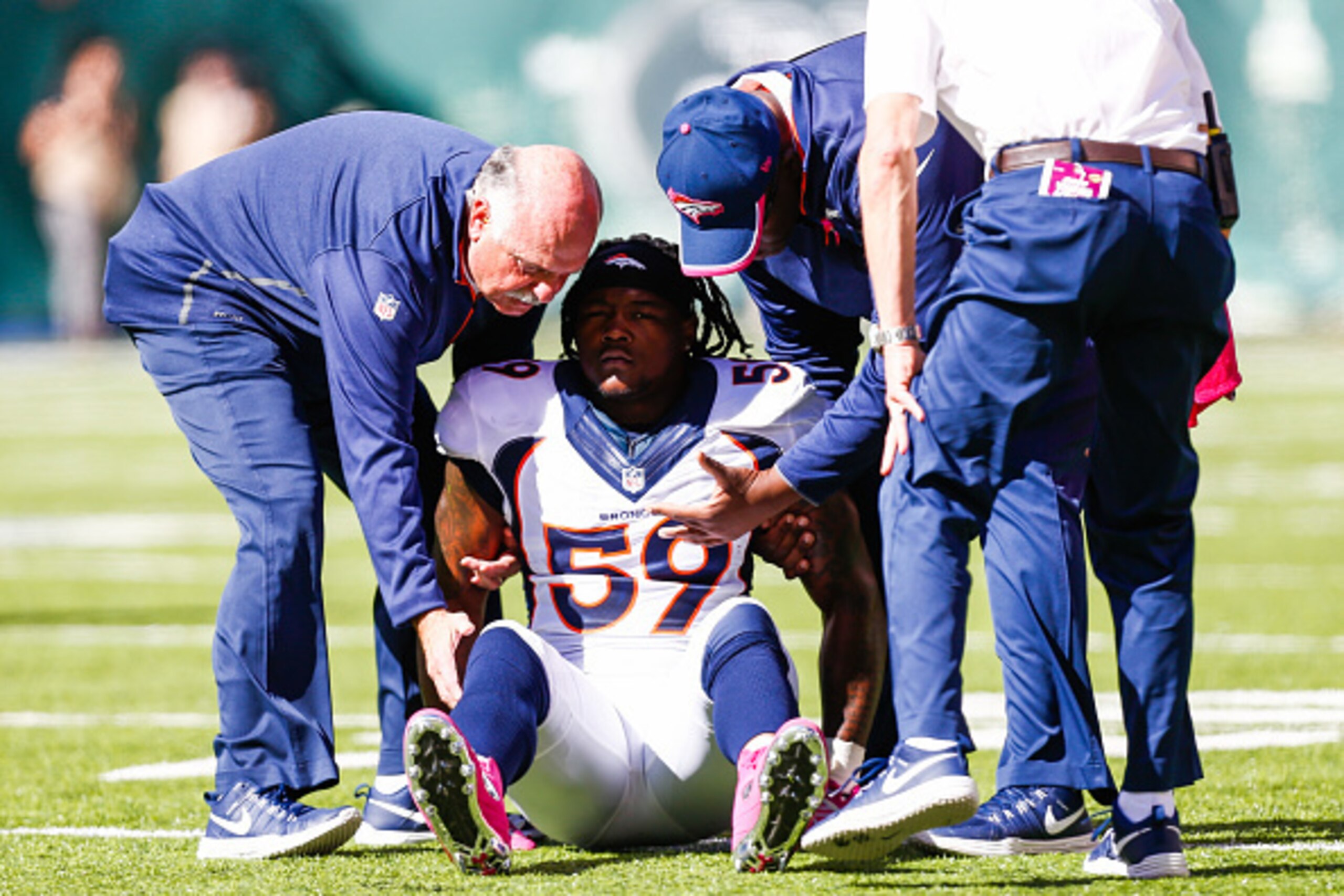EAST RUTHERFORD, NJ - OCTOBER 12: Danny Trevathan #59 of the Denver Broncos is helped by team trainers in the first quarter during a game against the New York Jets at MetLife Stadium on October 12, 2014 in East Rutherford, New Jersey. (Photo by Jeff Zele EAST RUTHERFORD, NJ - OCTOBER 12: Danny Trevathan #59 of the Denver Broncos is helped by team trainers in the first quarter during a game against the New York Jets at MetLife Stadium on October 12, 2014 in East Rutherford, New Jersey. (Photo by Jeff Zele