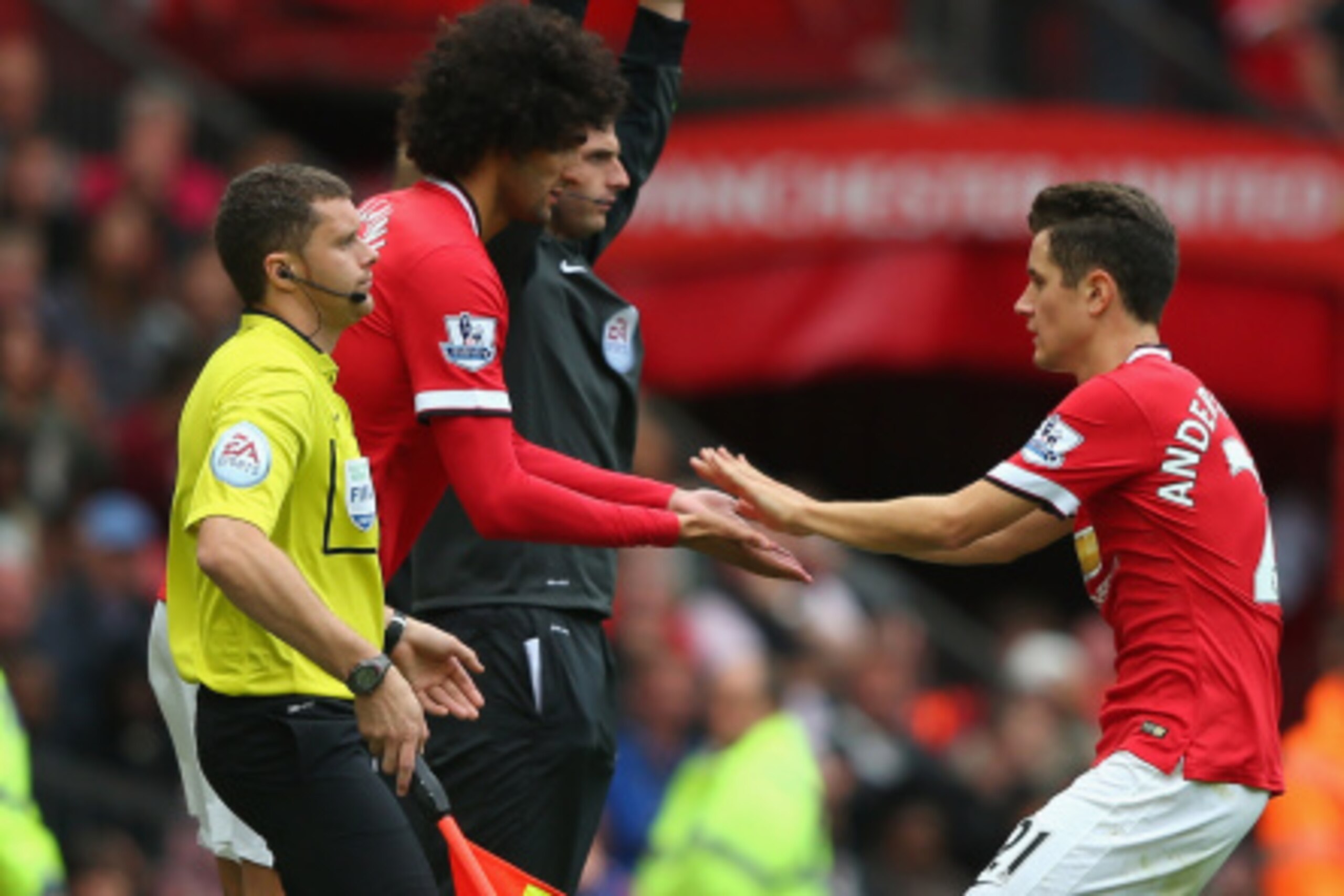 MANCHESTER, ENGLAND - AUGUST 16:  Marouane Fellaini of Manchester United replaces Ander Herrera (R) during the Barclays Premier League match between Manchester United and Swansea City at Old Trafford on August 16, 2014 in Manchester, England.  (Photo by A