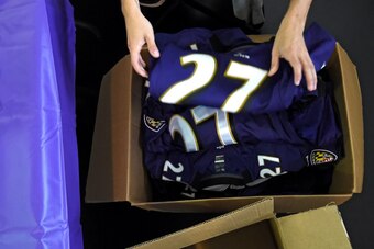 BALTIMORE, MD - SEPTEMBER 19: An authenticator puts the jersey of of former running back Ray Rice #27 of the Baltimore Ravens into a box 
after a football fan stood in line to exchange the jersey at M&T Bank Stadium on September 19, 2014 in Baltimore, Mar