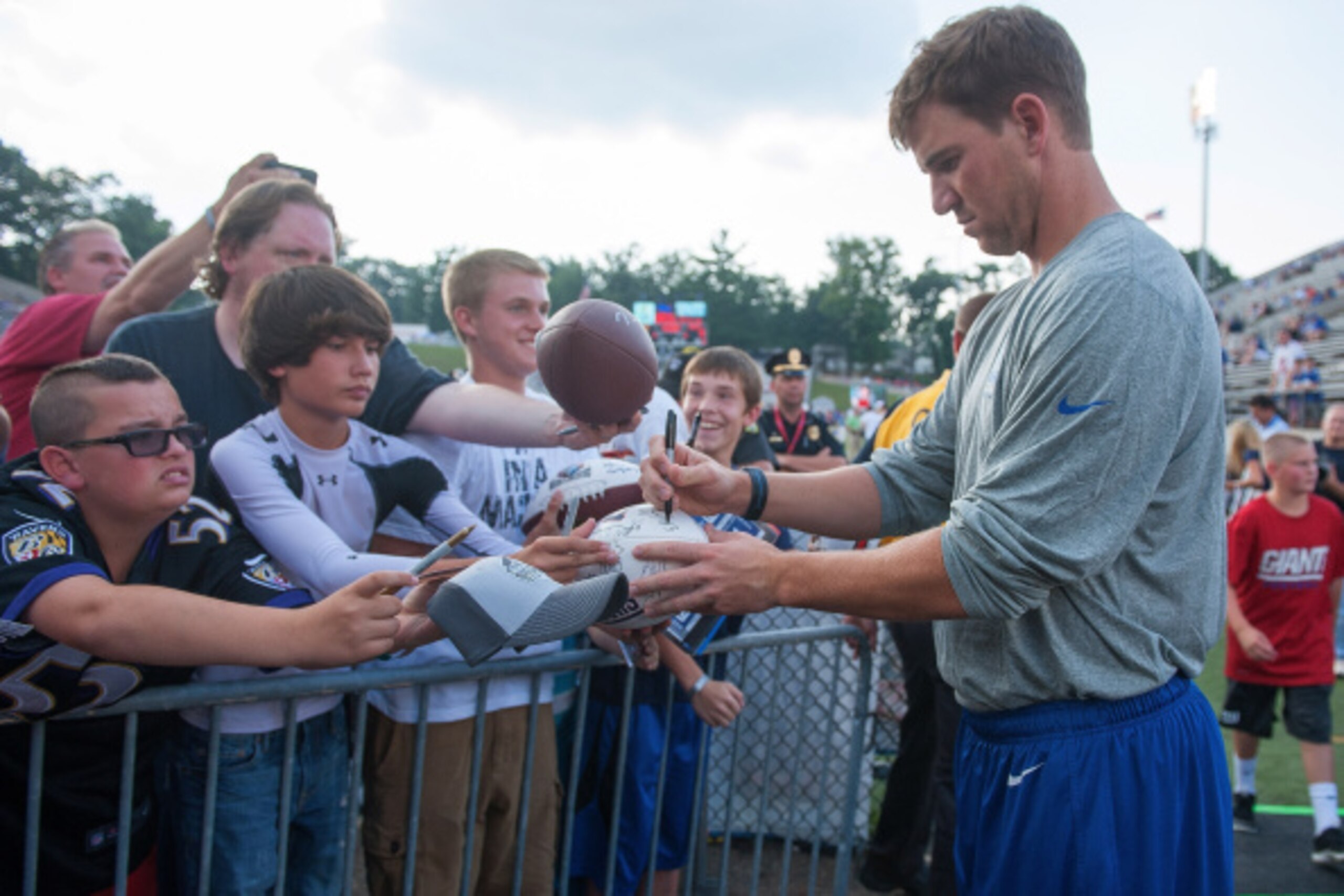 CANTON, OH - AUGUST 3: Quarterback Eli Manning #10 of the New York Giants signs autographs prior to a game against the Buffalo Bills at the 2014 NFL Hall of Fame Game at Fawcett Stadium on August 3, 2014 in Canton, Ohio. (Photo by Jason Miller/Getty Image