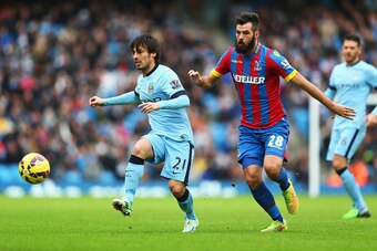 MANCHESTER, ENGLAND - DECEMBER 20: David Silva of Manchester City is closed down by Joe Ledley of Crystal Palace during the Barclays Premier League match between Manchester City and Crystal Palace at Etihad Stadium on December 20, 2014 in Manchester, Engl