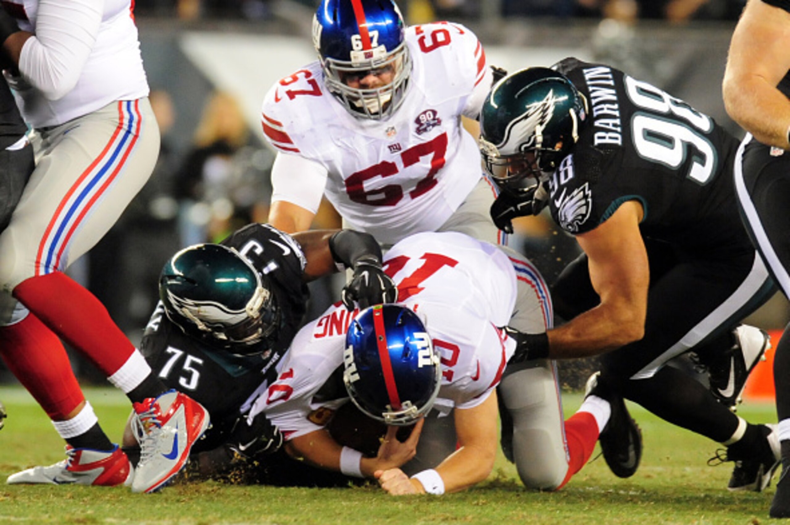 PHILADELPHIA, PA - OCTOBER 12: Quarterback Eli Manning #10 of the New York Giants is sacked by defensive end Vinny Cury #75 of the Philadelphia Eagles during a football game at Lincoln Financial Field on October 12, 2014 in Philadelphia, Pennsylvania. (Ph