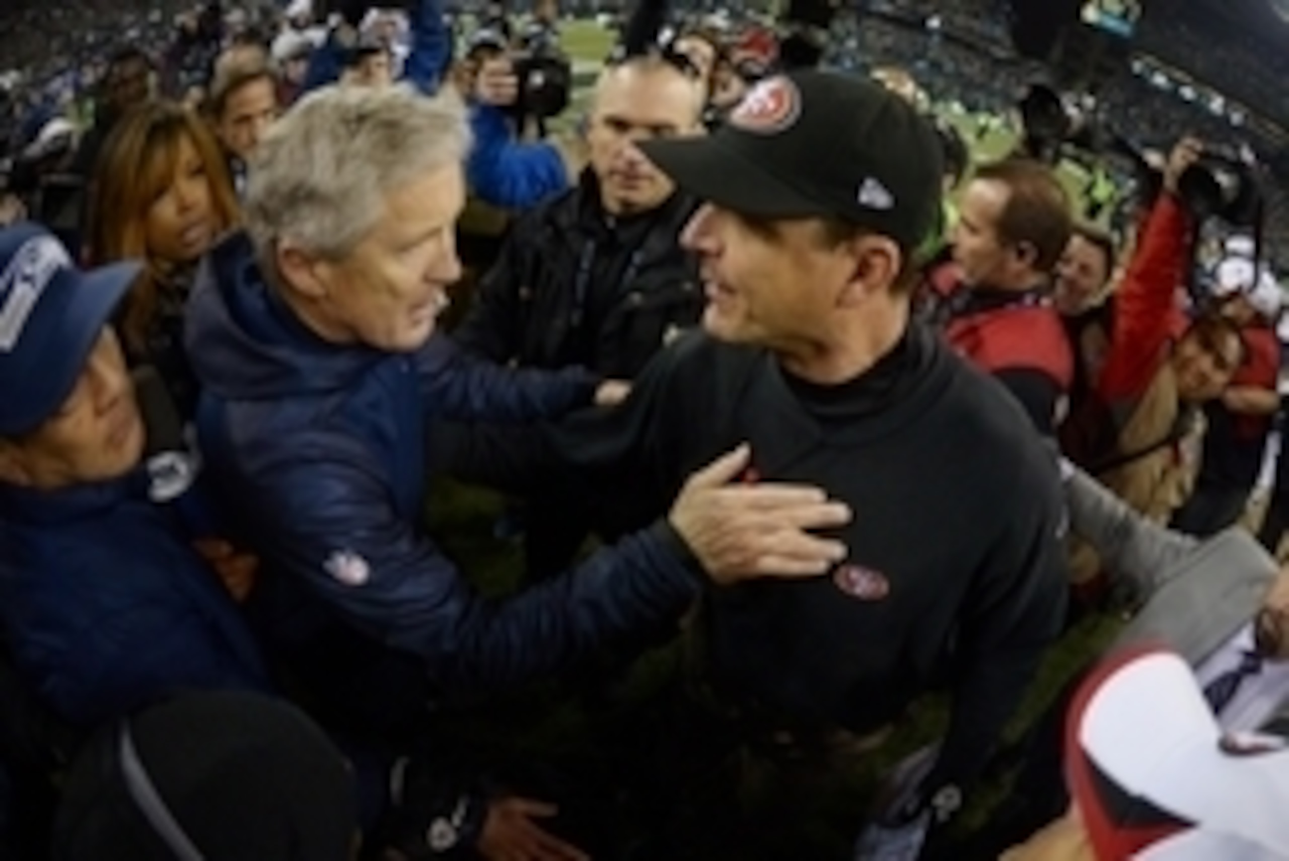 Jan 19, 2014; Seattle, WA, USA; Seattle Seahawks head coach Pete Carroll (left) shakes hands with San Francisco 49ers head coach Jim Harbaugh (right) after the 2013 NFC Championship football game at CenturyLink Field. Mandatory Credit: Kirby Lee-USA TODAY