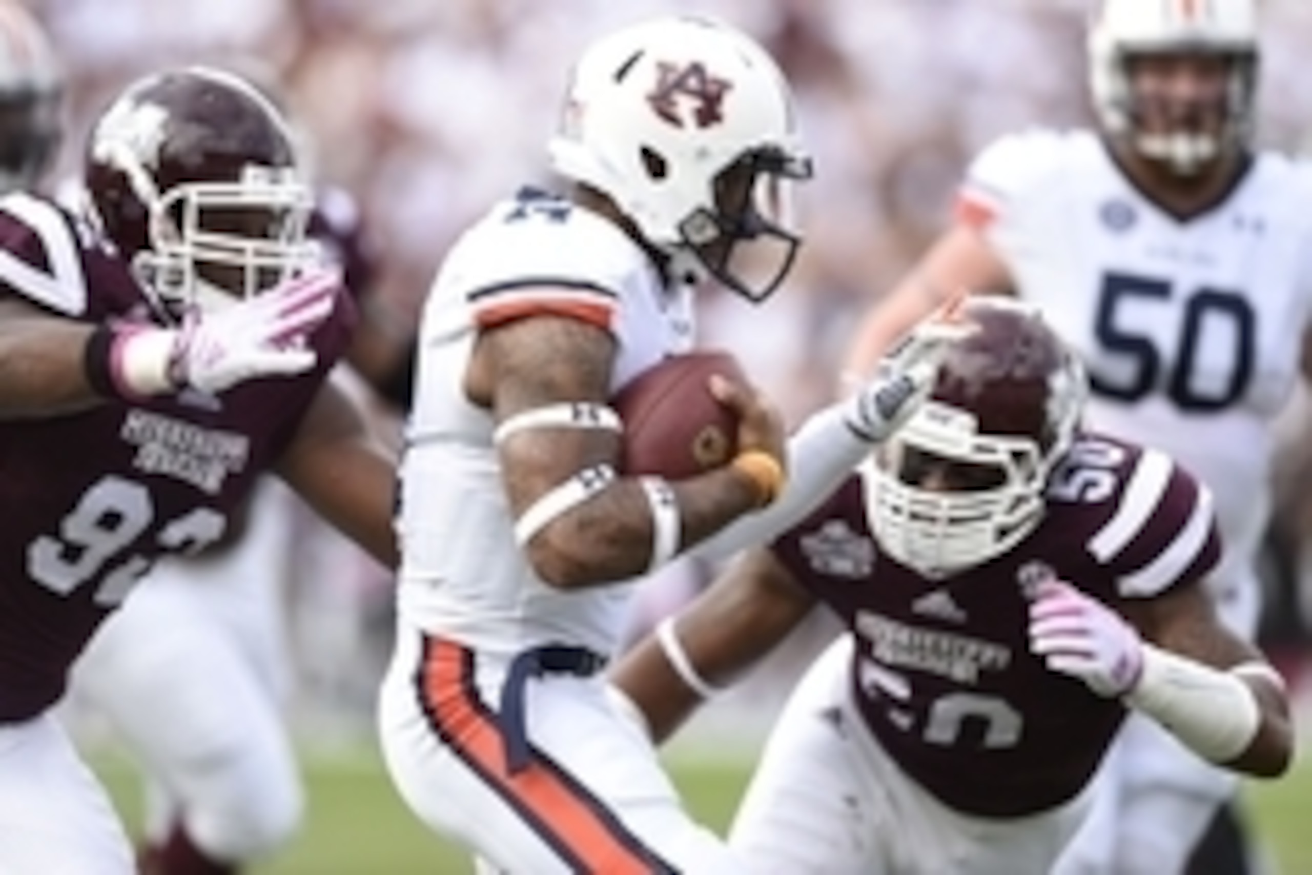 Oct 11, 2014; Starkville, MS, USA; Auburn Tigers quarterback Nick Marshall (14) scrambles up the field under pressure form Mississippi State Bulldogs defensive lineman Kaleb Eulls (92) and linebacker Benardrick McKinney (50)  during the first quarter at D