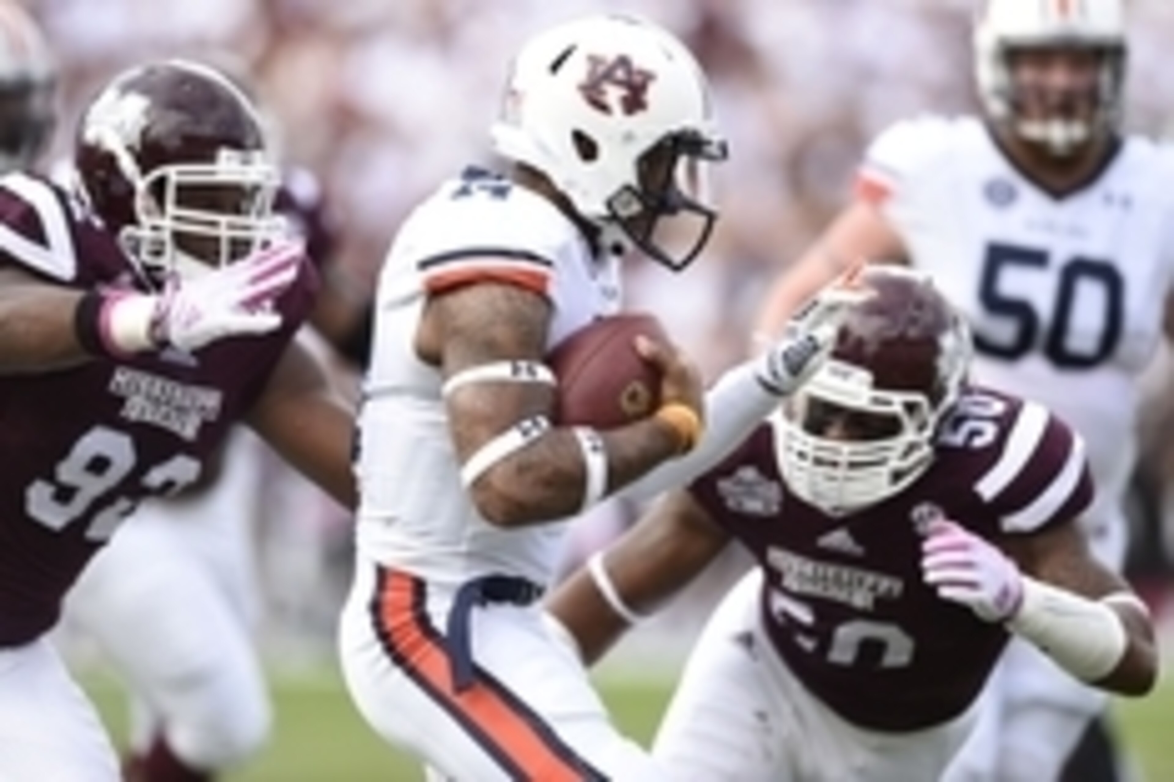 Oct 11, 2014; Starkville, MS, USA; Auburn Tigers quarterback Nick Marshall (14) scrambles up the field under pressure form Mississippi State Bulldogs defensive lineman Kaleb Eulls (92) and linebacker Benardrick McKinney (50)  during the first quarter at D