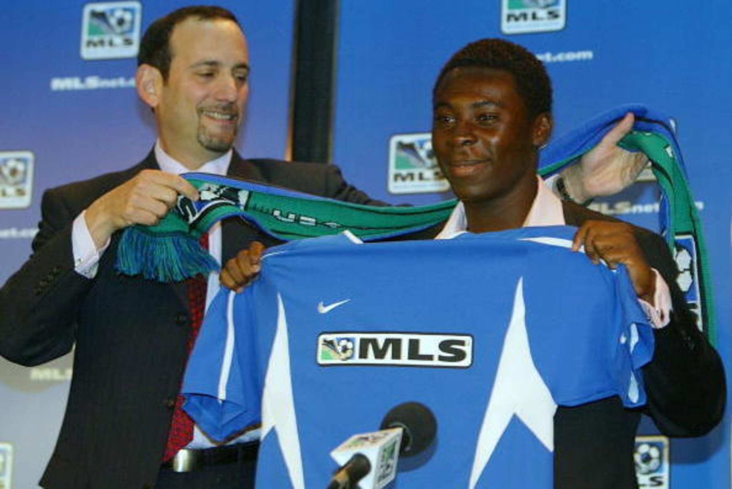 NEW YORK CITY - NOVEMBER 19:  Major League Soccer Commissioner Don Garber gives Freddy Adu a MLS jersey and scarf during a press conference that announce that Adu signed a multi-year contract with MLS on November 19, 2003 at Madison Square Garden in New Y