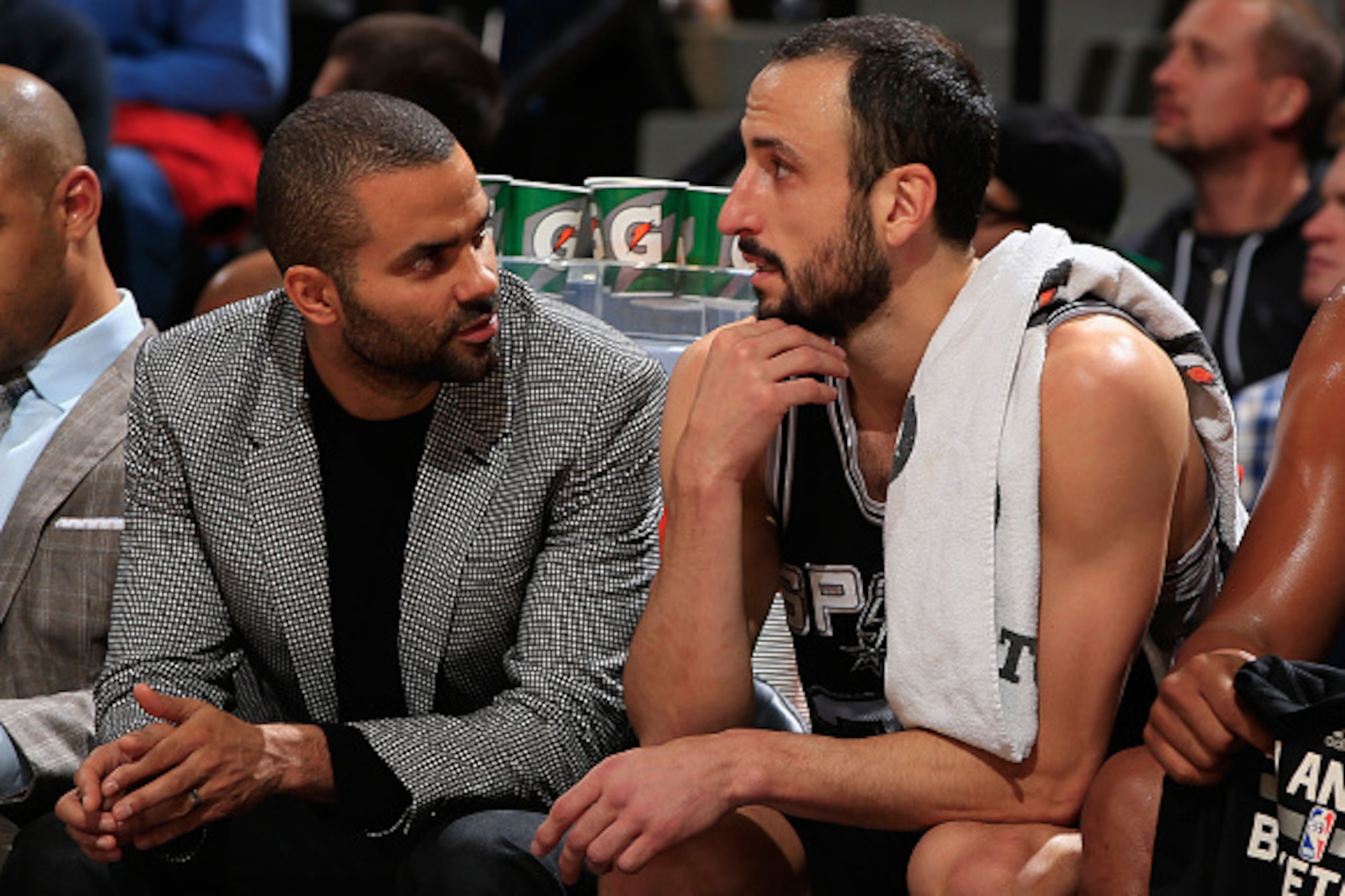 DENVER, CO - DECEMBER 14:  Tony Parker #9 of the San Antonio Spurs talks to Manu Ginobili #20 of the San Antonio Spurs as Parker sits out the game due to injury at Pepsi Center on December 14, 2014 in Denver, Colorado. NOTE TO USER: User expressly acknowl