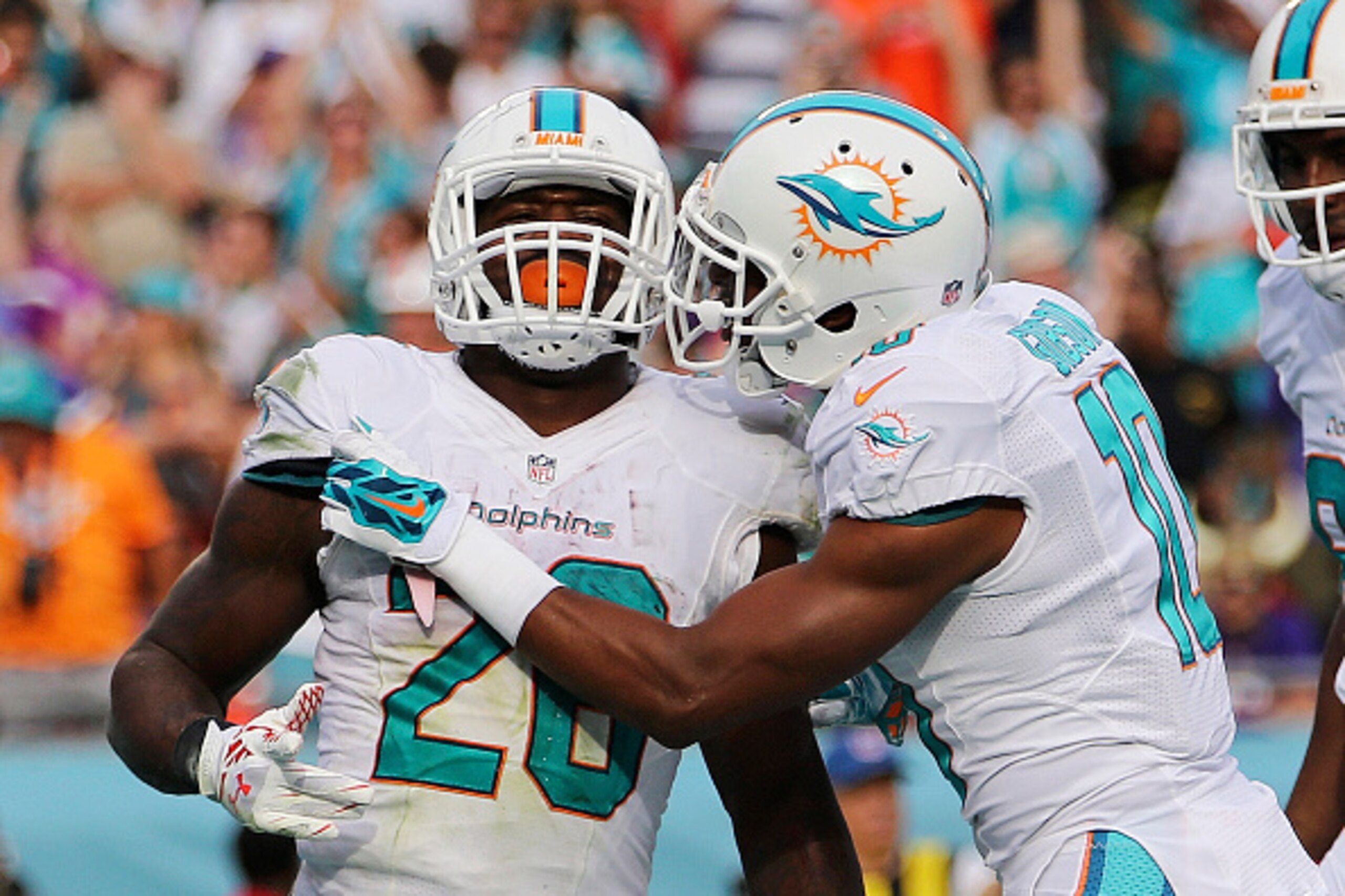MIAMI GARDENS, FL - DECEMBER 21:  Running back Lamar Miller #26 of the Miami Dolphins celebrates with wide receiver Brandon Gibson #10 after his third quarter touchdown against the Minnesota Vikings at Sun Life Stadium on December 21, 2014 in Miami Garden