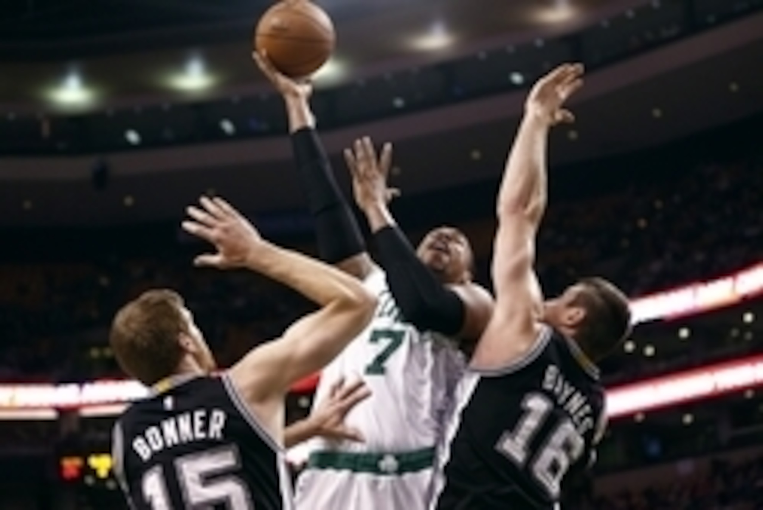 Nov 30, 2014; Boston, MA, USA; Boston Celtics forward Jared Sullinger (7) shoots the ball against San Antonio Spurs forward Matt Bonner (15) and forward Aron Baynes (16) during the first half at TD Garden. Mandatory Credit: Mark L. Baer-USA TODAY Sports