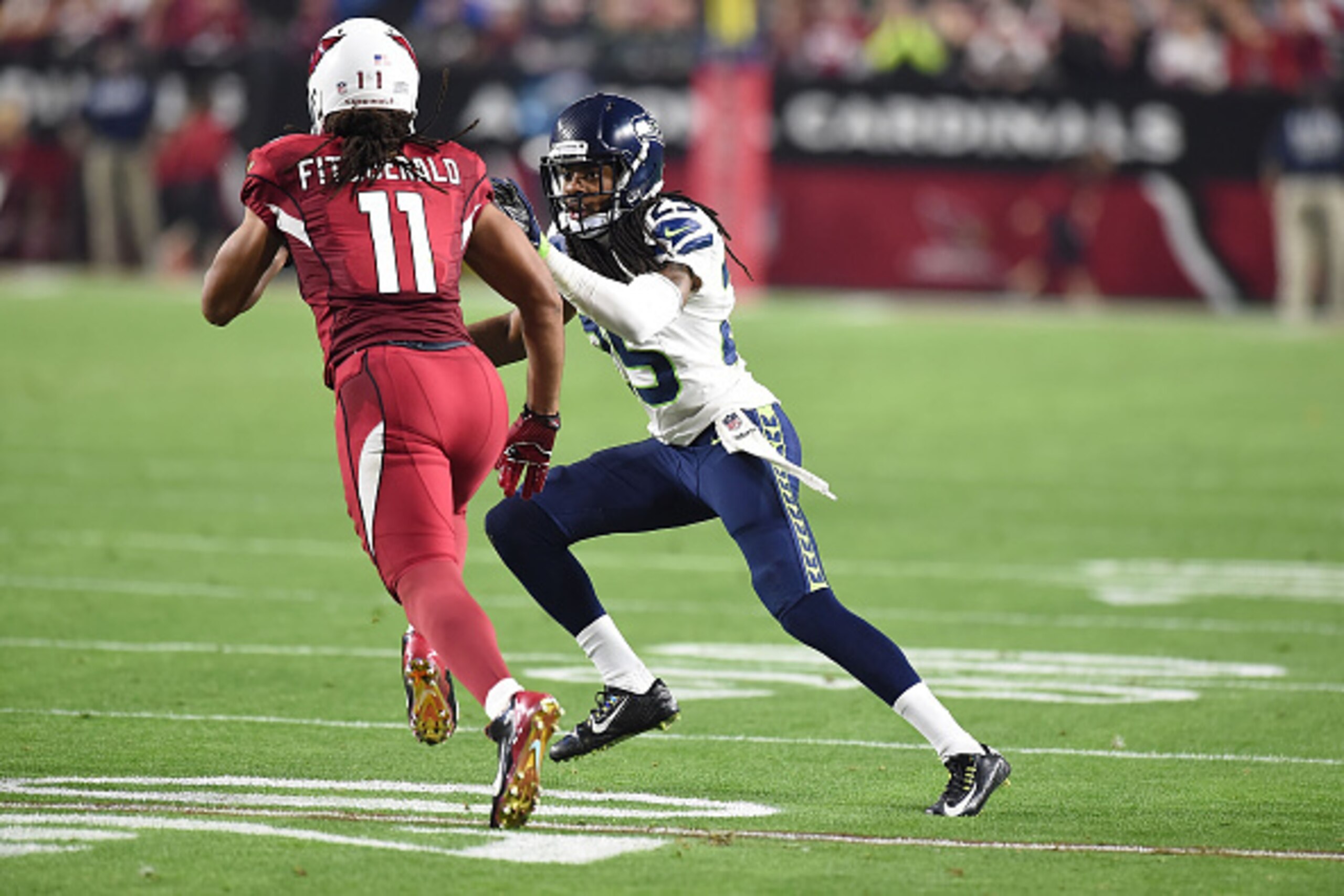 GLENDALE, AZ - DECEMBER 21:  Cornerback Richard Sherman #25 of the Seattle Seahawks defends wide receiver Larry Fitzgerald #11 of the Arizona Cardinals in the second half of the NFL game at University of Phoenix Stadium on December 21, 2014 in Glendale, A