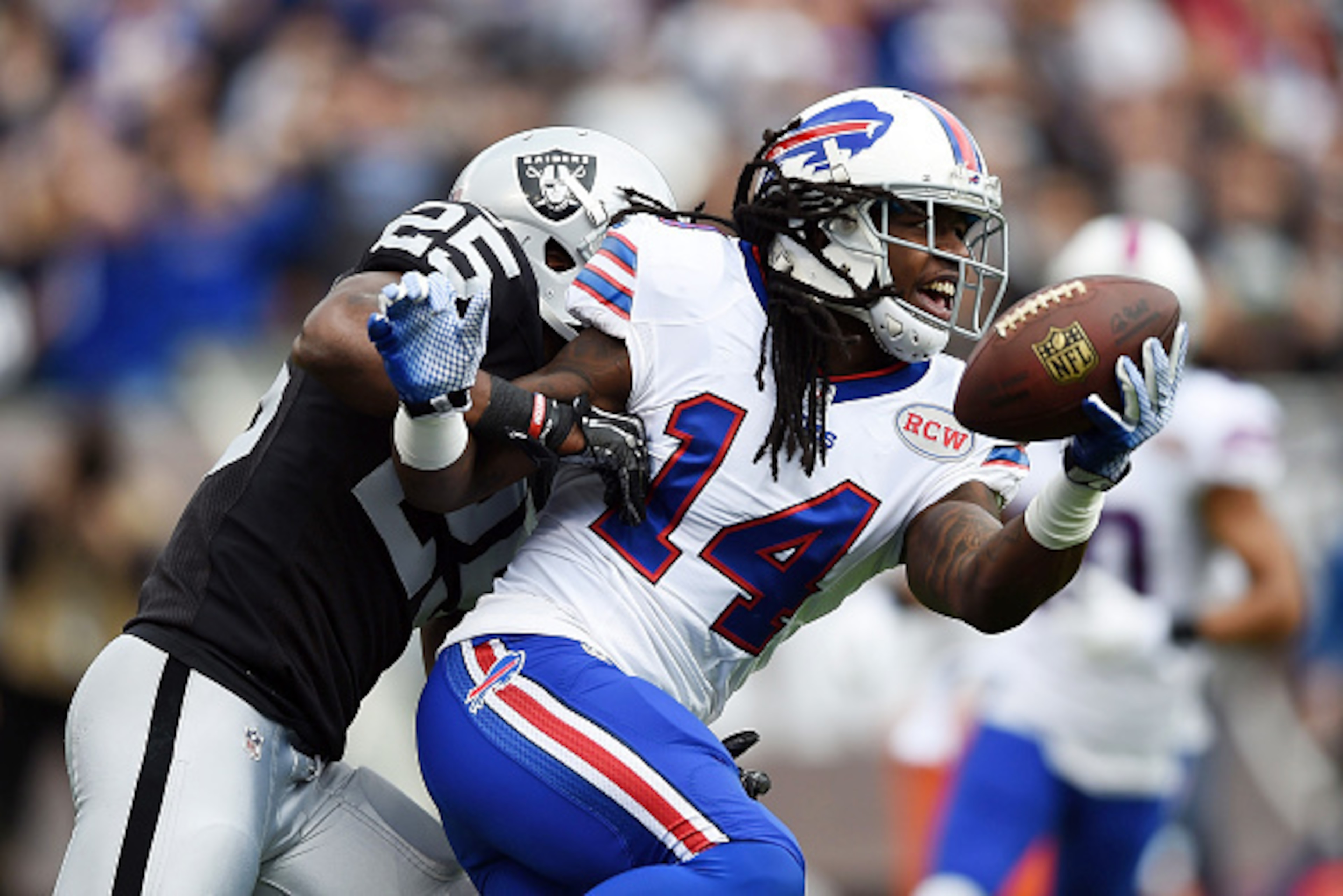OAKLAND, CA - DECEMBER 21:  Sammy Watkins #14 of the Buffalo Bills fights the tackle of D.J. Hayden #25 of the Oakland Raiders for a touchdown in the first quarter at O.co Coliseum on December 21, 2014 in Oakland, California.  (Photo by Thearon W. Henders