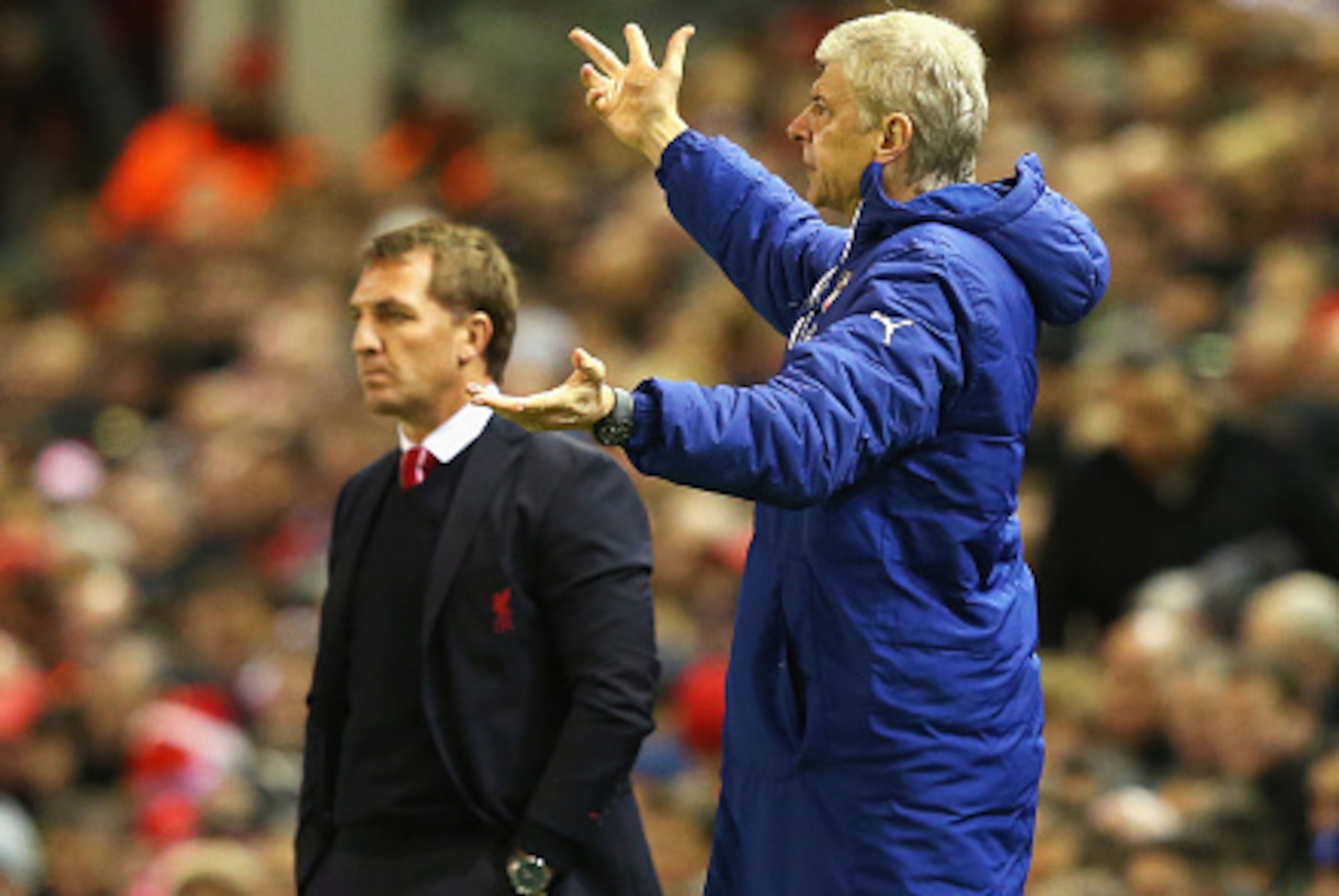 LIVERPOOL, ENGLAND - DECEMBER 21: Arsene Wenger, manager of Arsenal gestures with Brendan Rodgers, manager of Liverpool during the Barclays Premier League match between Liverpool and Arsenal at Anfield on December 21, 2014 in Liverpool, England.  (Photo b