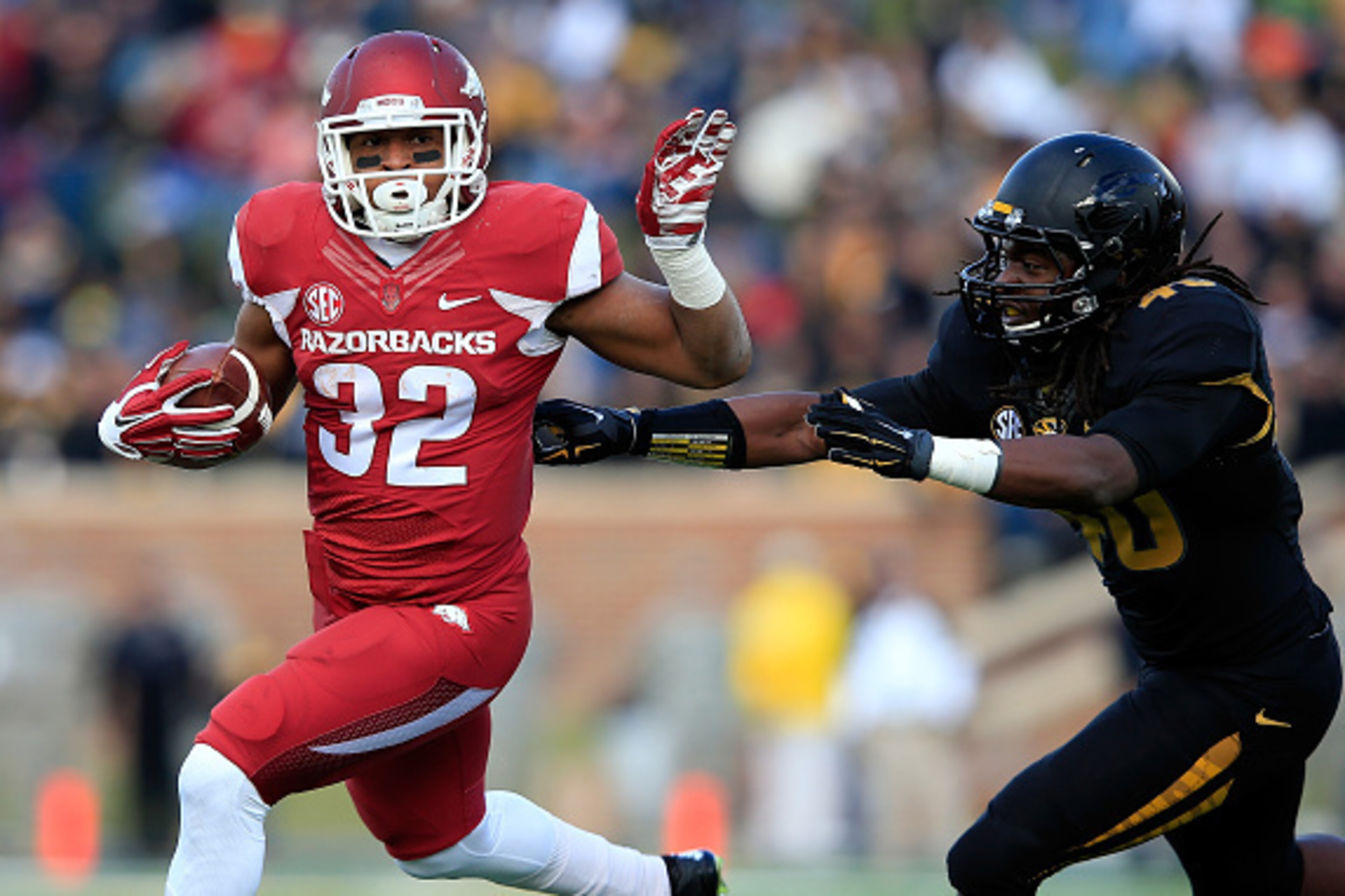 COLUMBIA, MO - NOVEMBER 28:  Jonathan Williams #32 of the Arkansas Razorbacks carries the ball as Clarence Green #40 of the Missouri Tigers defends during the game at Faurot Field/Memorial Stadium on November 28, 2014 in Columbia, Missouri.  (Photo by Jam