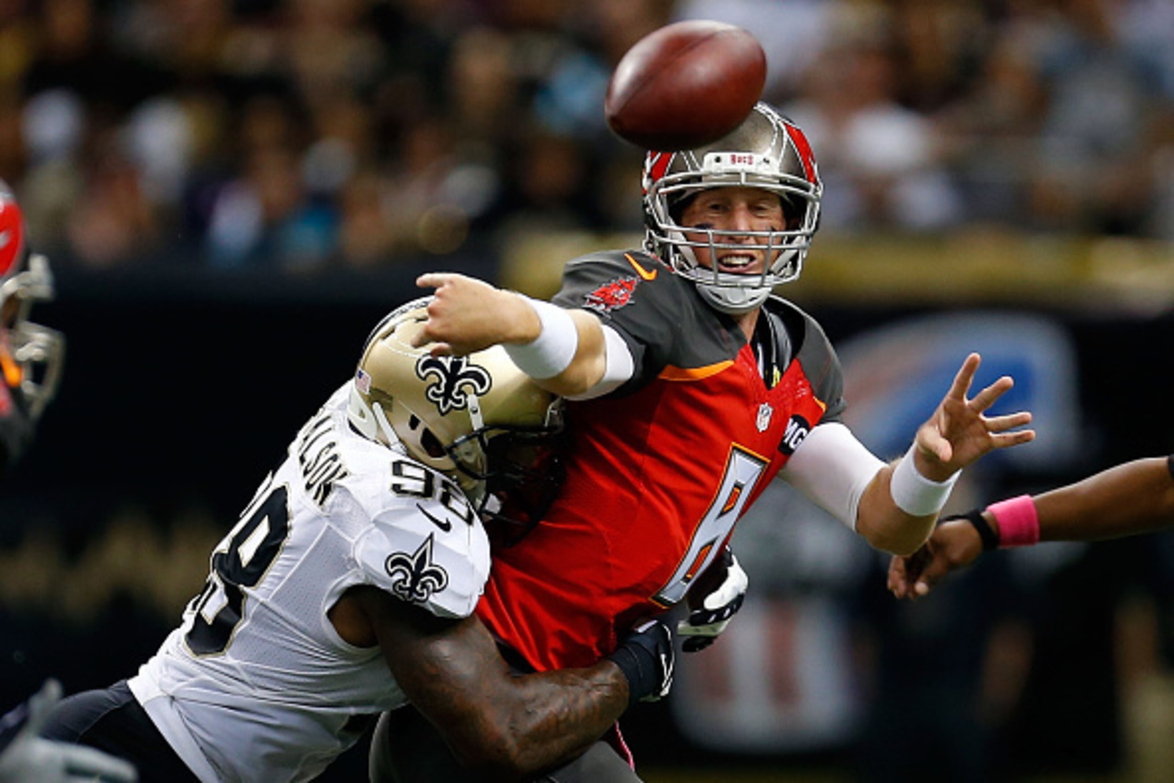 NEW ORLEANS, LA - OCTOBER 05:  Mike Glennon #8 of the Tampa Bay Buccaneers is pressured by Parys Haralson #98 of the New Orleans Saints during the fourth quarter of a game at the Mercedes-Benz Superdome on October 5, 2014 in New Orleans, Louisiana.  (Phot
