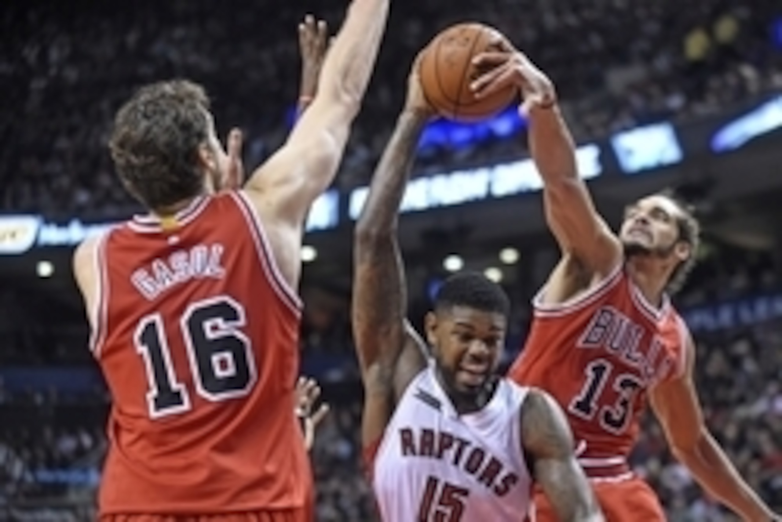 Nov 13, 2014; Toronto, Ontario, CAN;  Chicago Bulls forward Pau Gasol (16) and center Joakim Noah (13) block Toronto Raptors forward Amir Johnson (15) during the third quarter at Air Canada Centre. Chicago won 100 - 93. Mandatory Credit: Peter Llewellyn-U